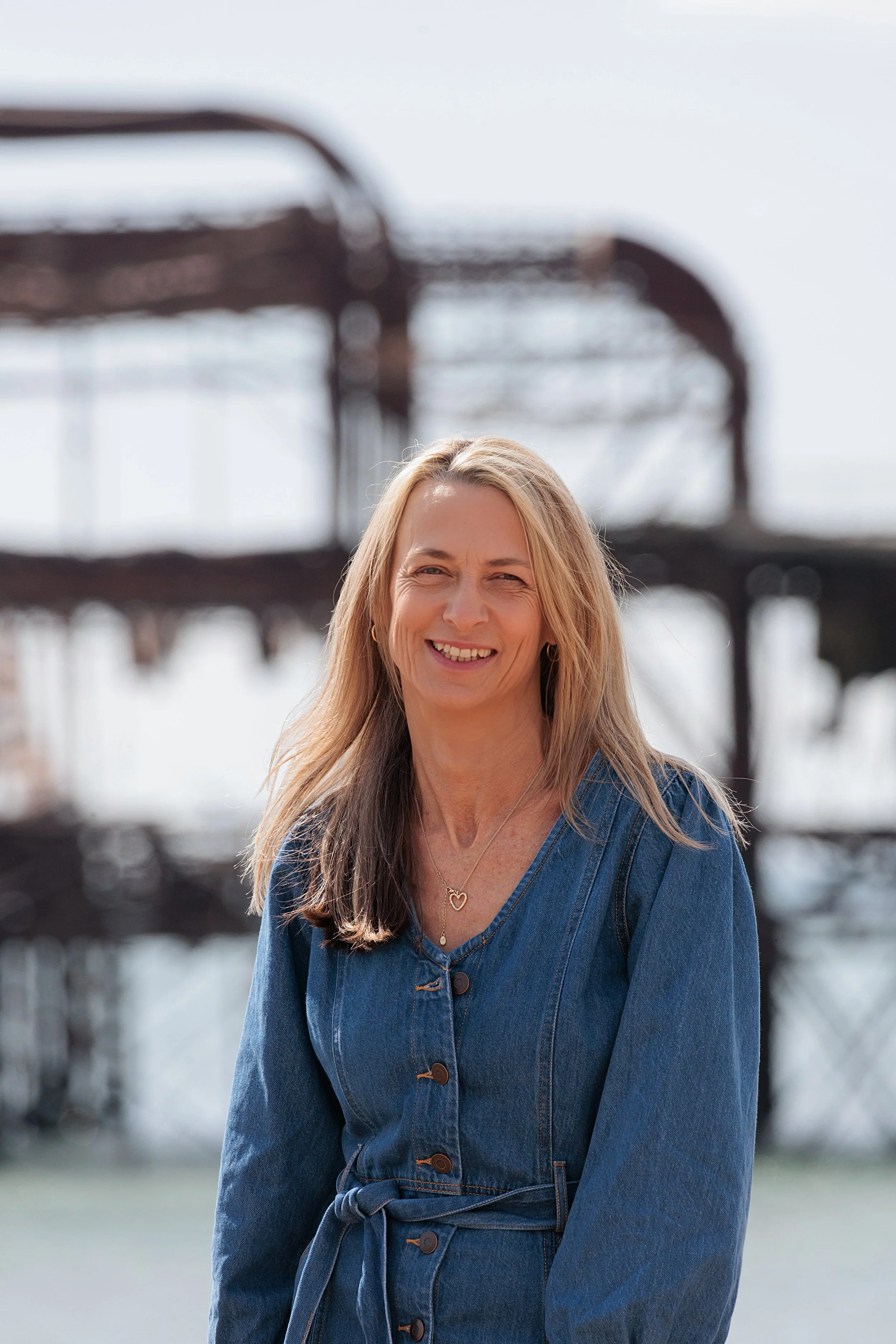 Woman smiling against out of focus backdrop of West Pier