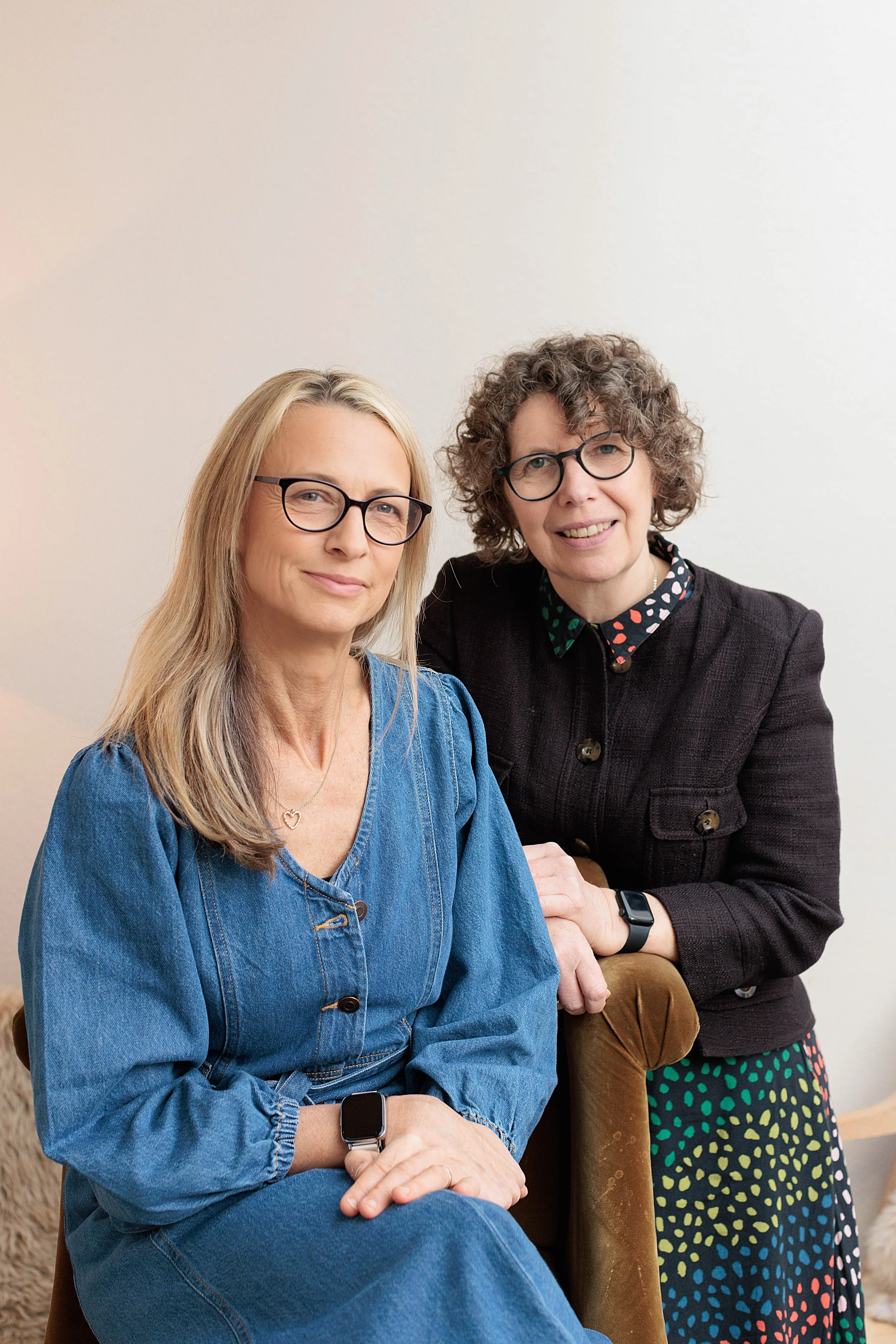 Two professional women posed towards camera