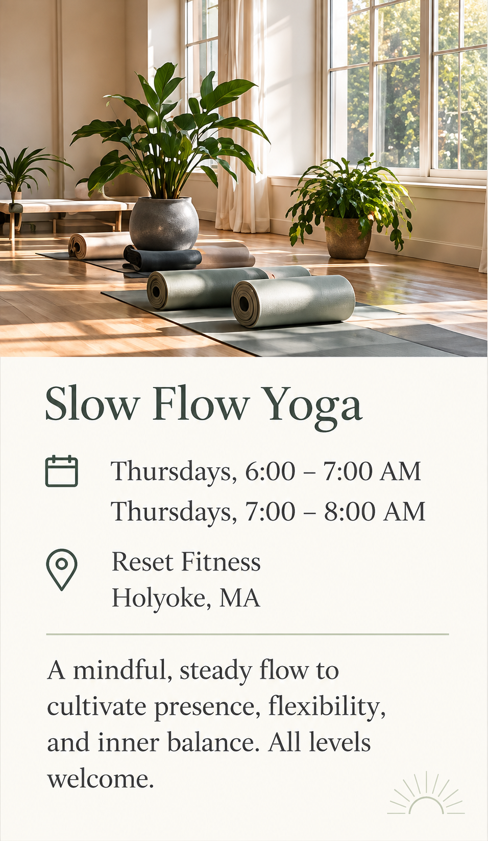 An indoor yoga studio with large windows, potted plants, yoga mats, and sunlight streaming in.