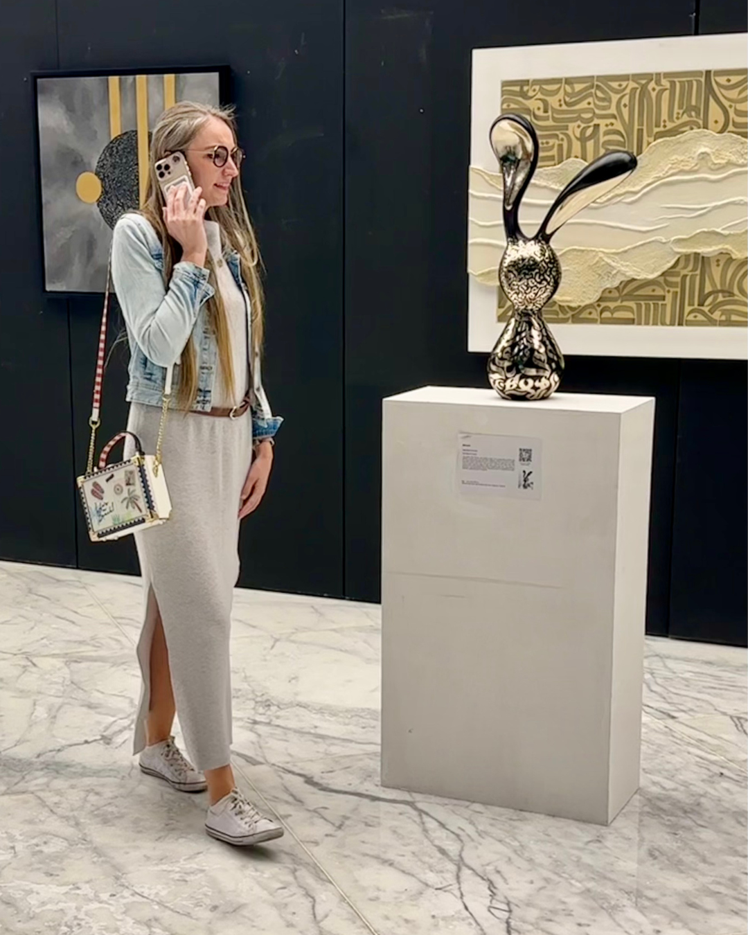 Martina Kikic taking a call in an art gallery in Dubai