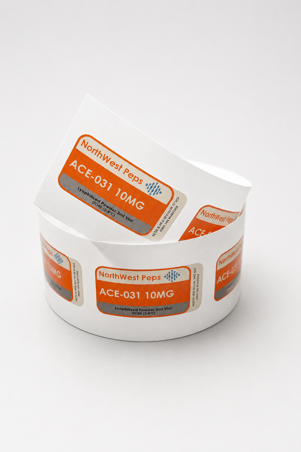 Roll of labels with orange, gray, and white design, reading 'NorthWest Peps ACE-031 10MG Lyophilized Powder 3ml Vial' on a white background.