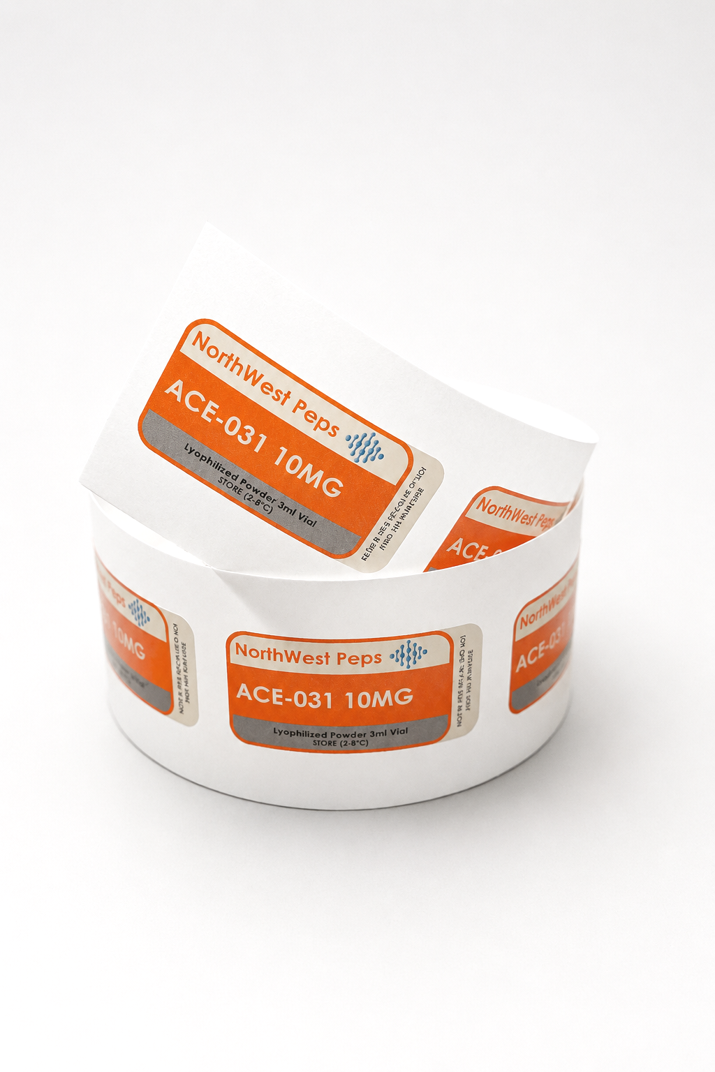 Roll of labels on a white surface, each label reads "Northwest Peps, ACE-031 10MG, Lyophilized Powder 3ml Vial, STORE (2-8°C)."