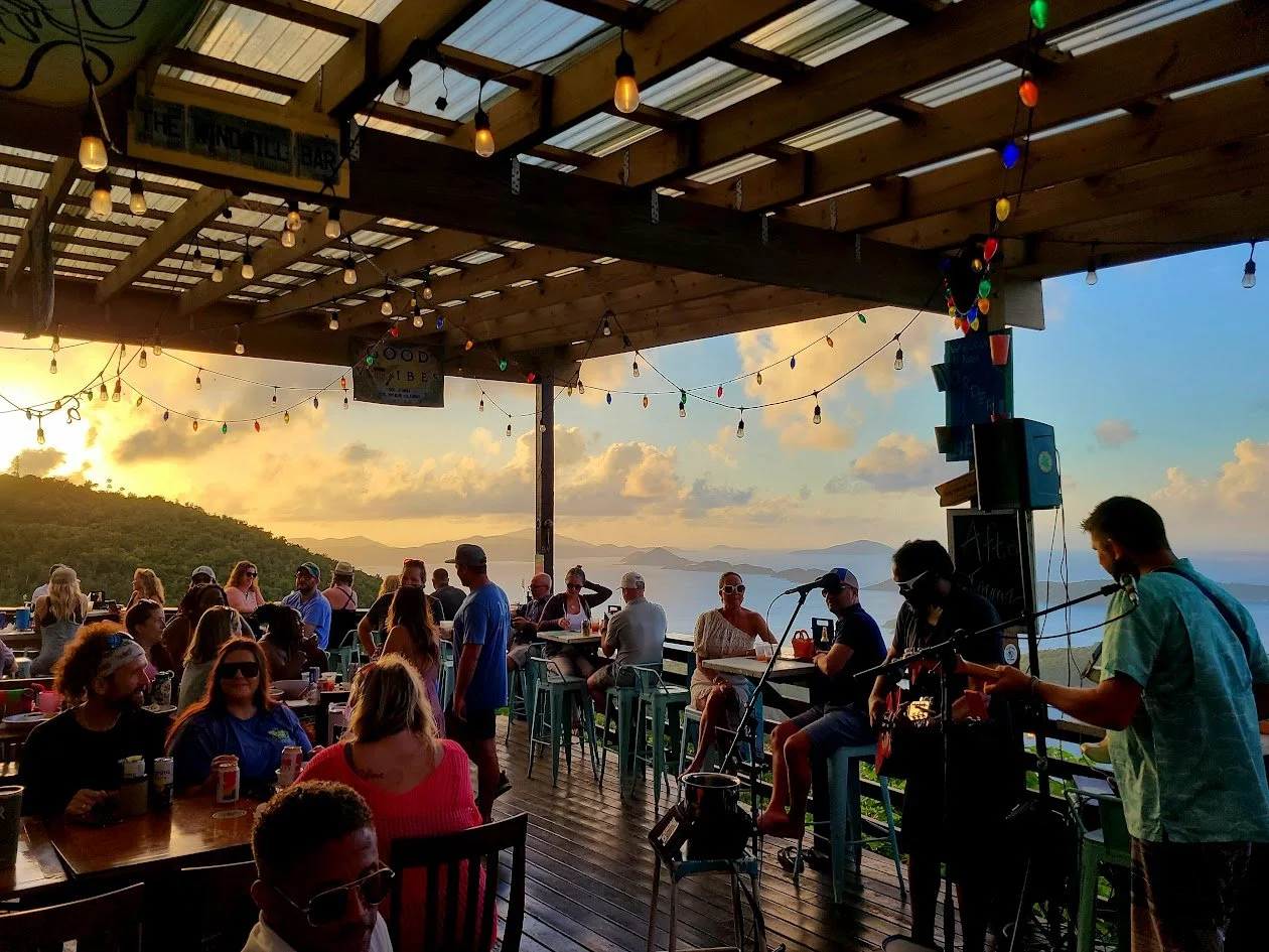 Outdoor bar with a view of the ocean and mountains at sunset, Windmill Bar, St John USVI