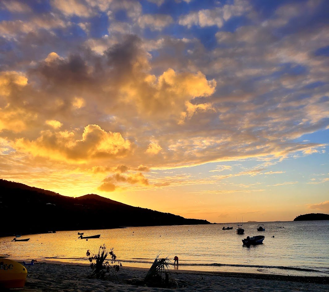 Sunset over a calm bay with boats anchored near the shore, Hull Bay, St Thomas USVI