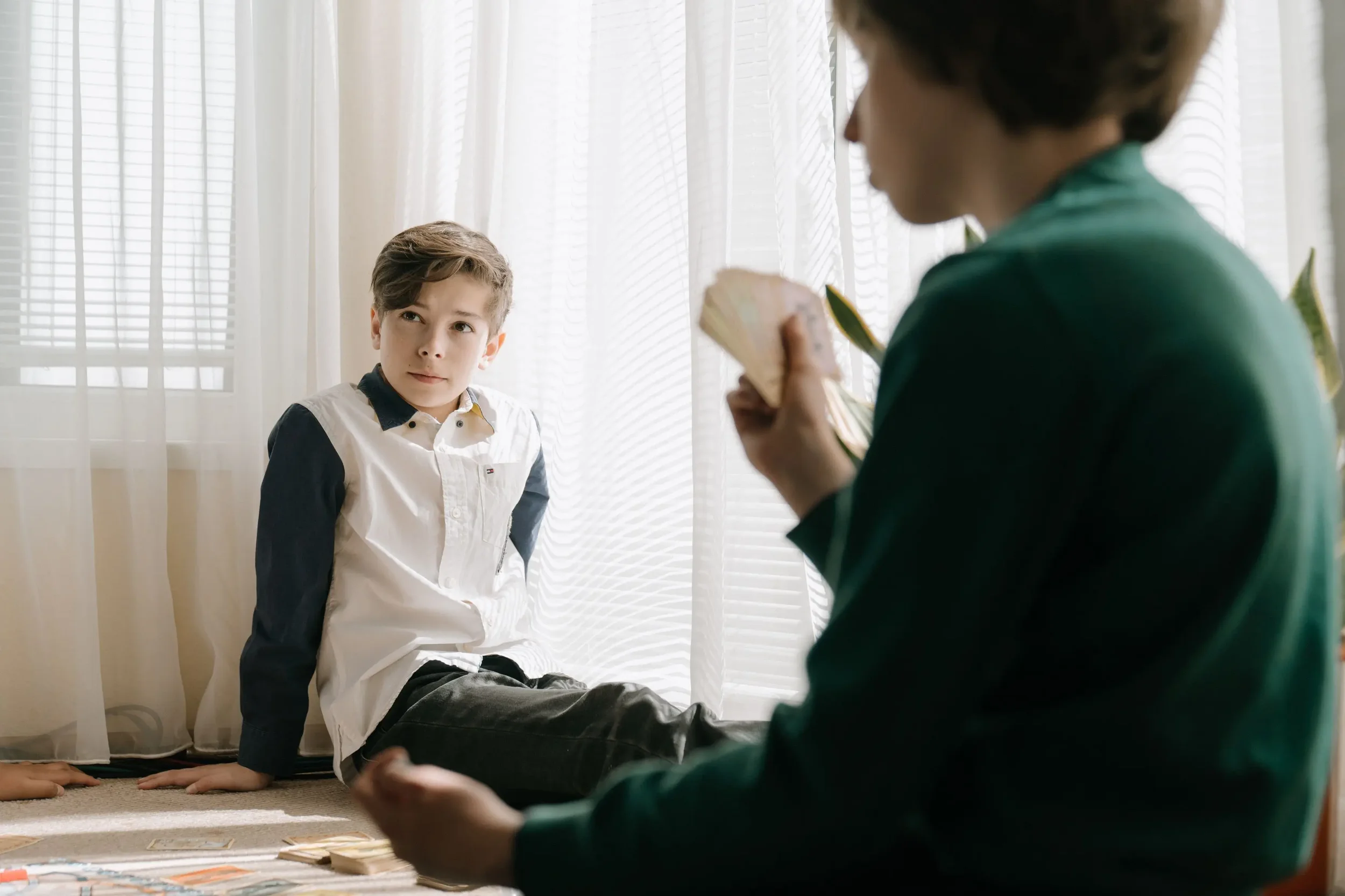 Child talking with a therapist during a counseling session, illustrating EMDR and talk therapy options for children.