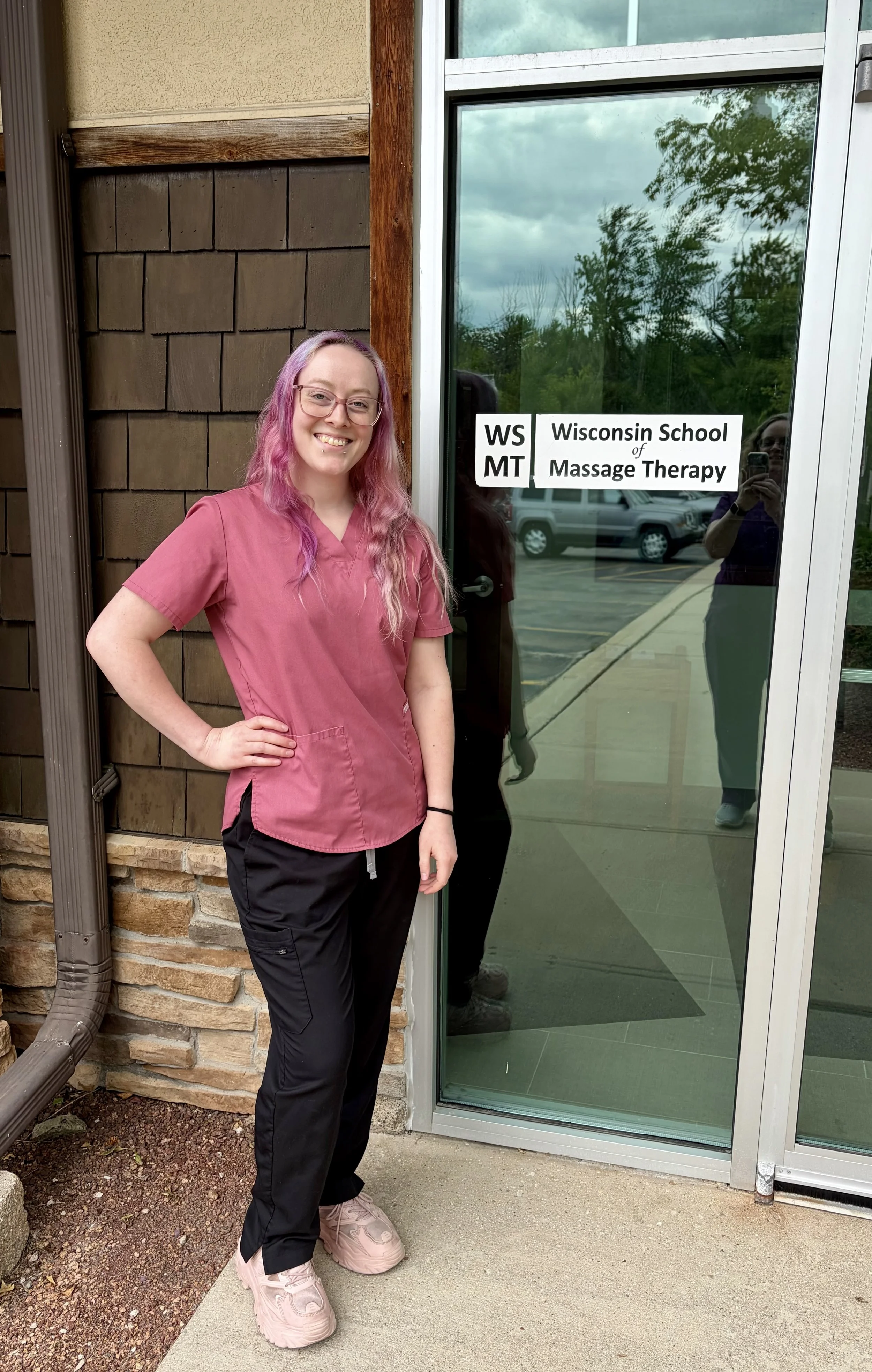 Ennis in front of Wisconsin School of Massage Therapy in Germantown