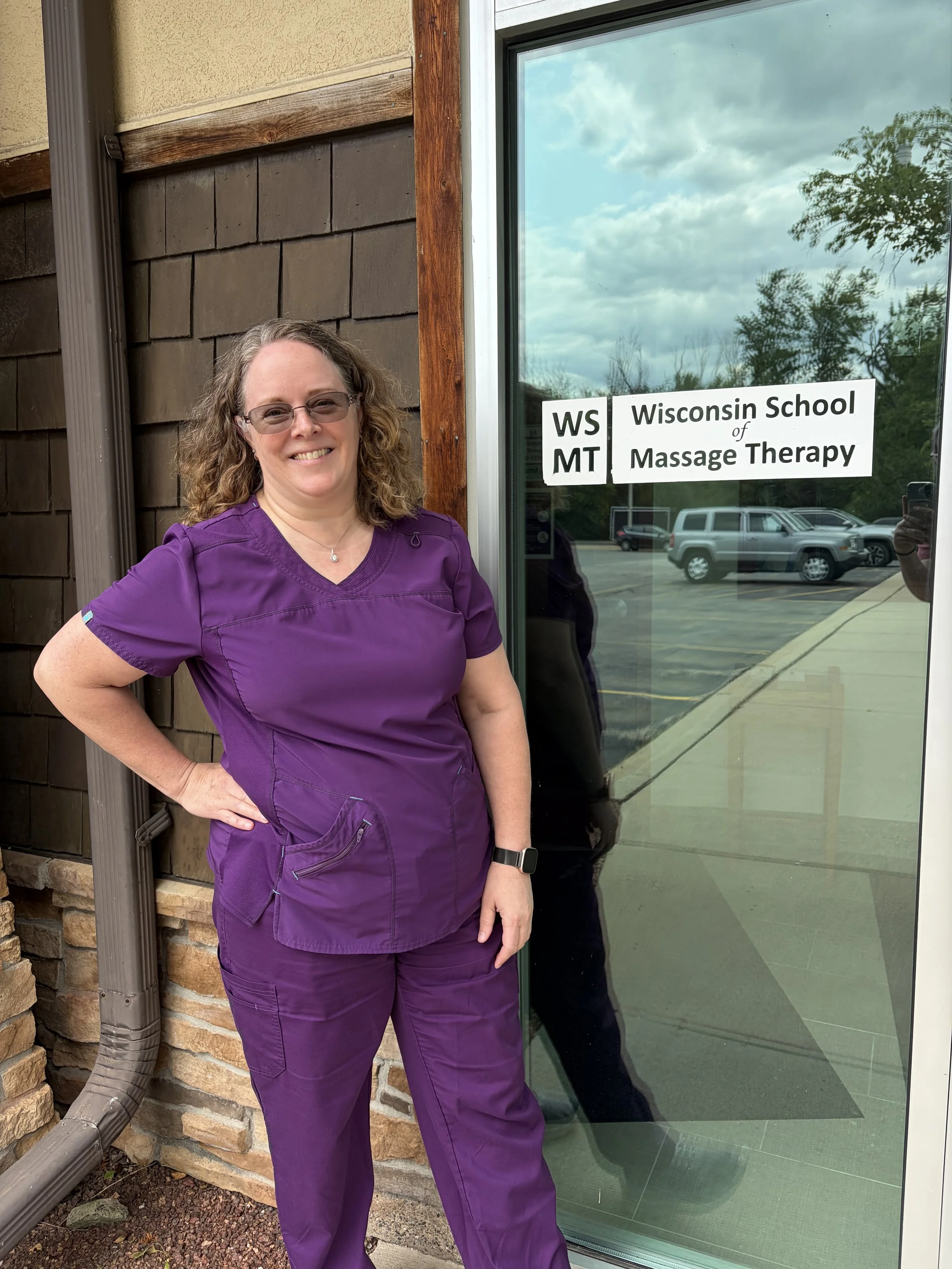 Karen in front of Wisconsin School of Massage Therapy in Germantown
