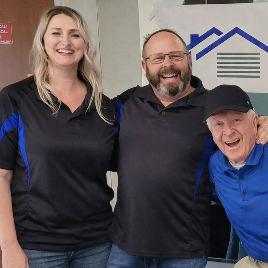 Three smiling people, two men and one woman