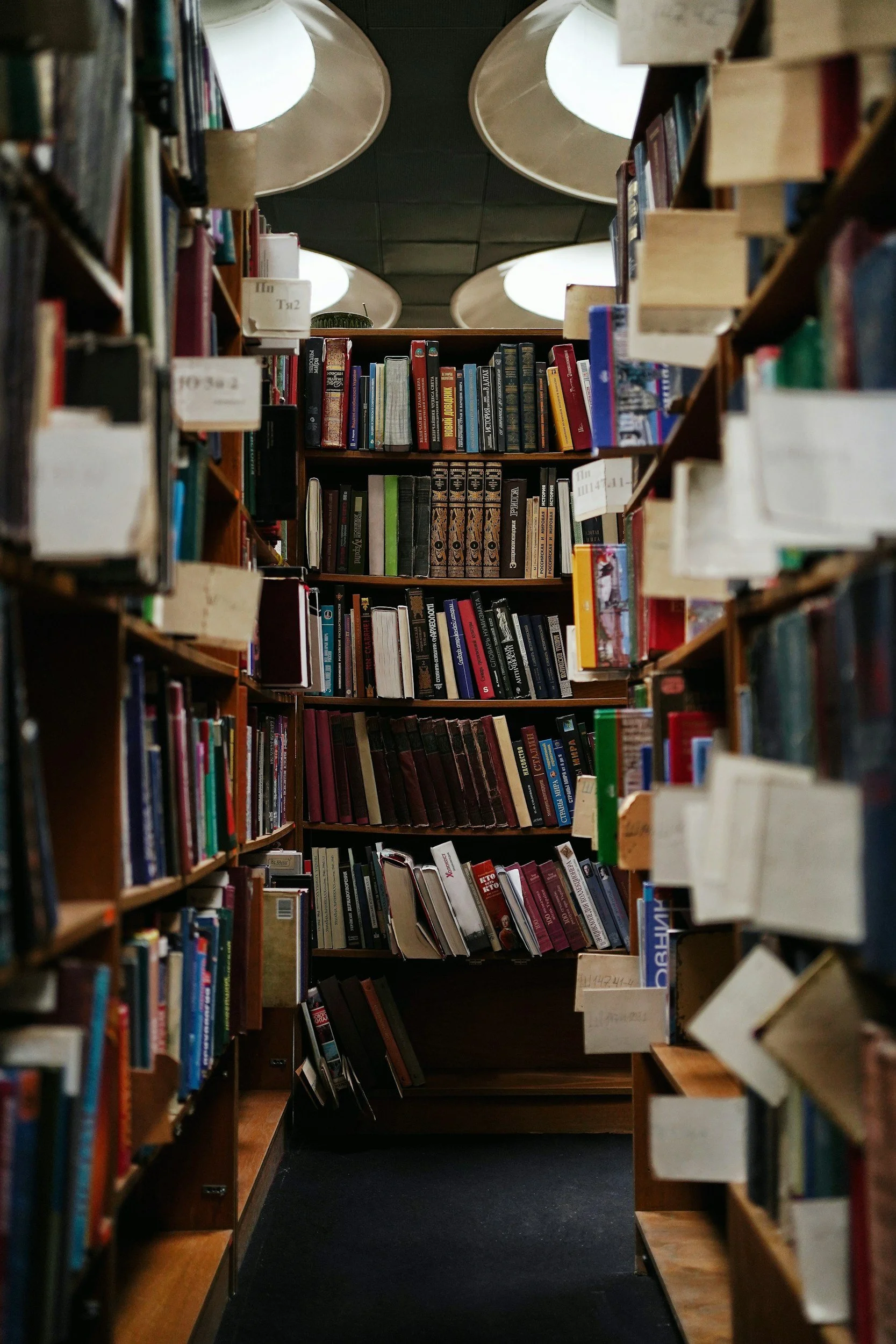 Bookshelves filled with books in a library aisle.