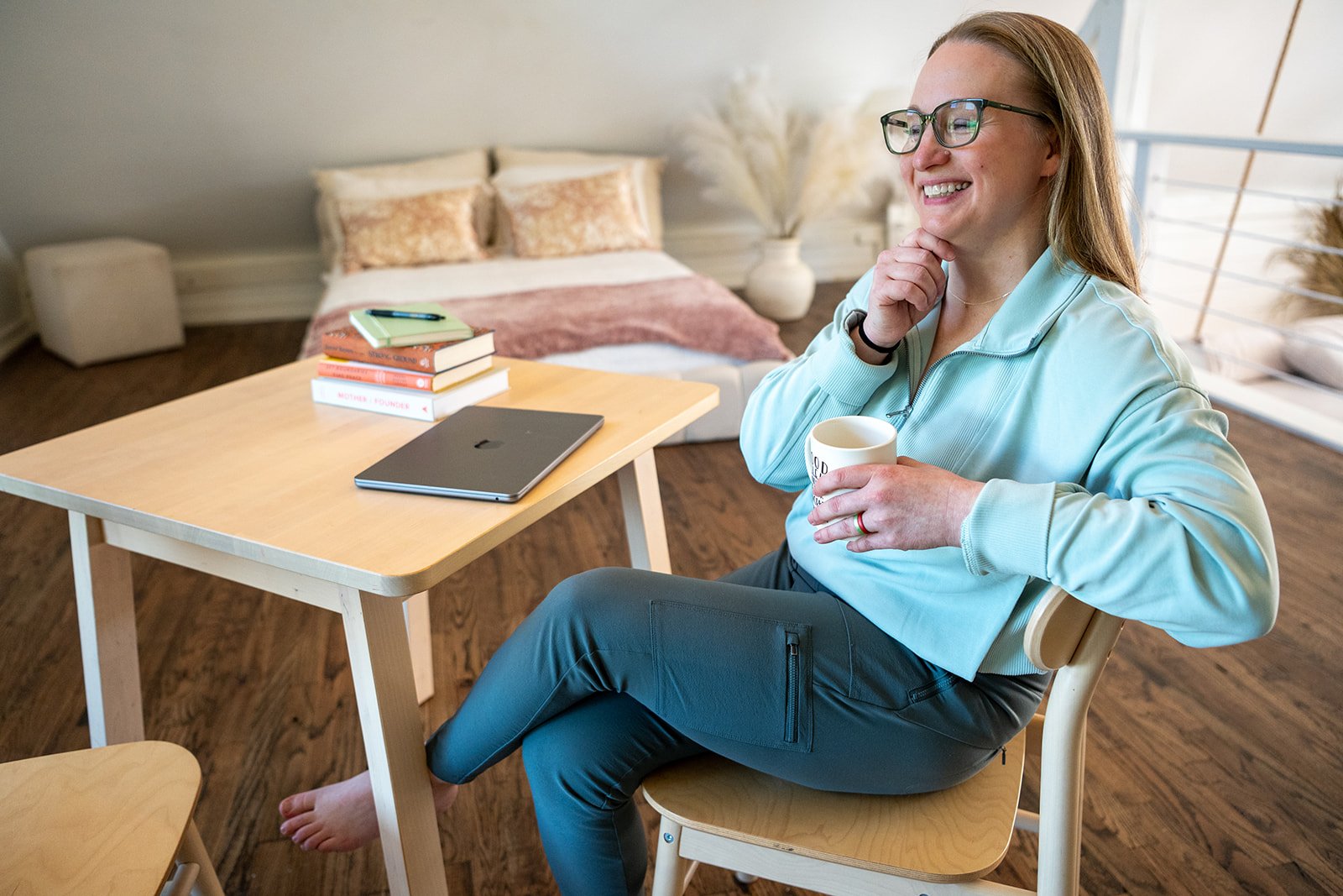 dr amanda townsend sitting at a table during a brand shoot for root and rise consulting