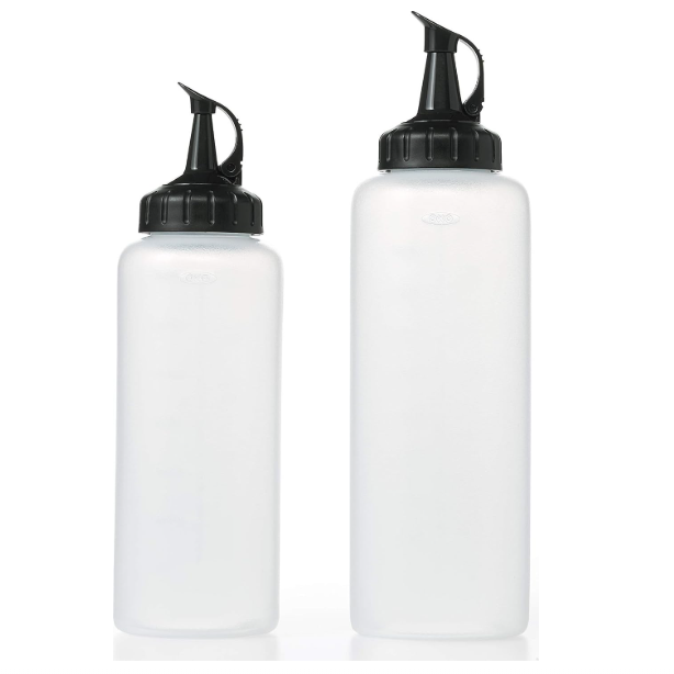 Two clear plastic squeeze bottles in different sizes with black lids