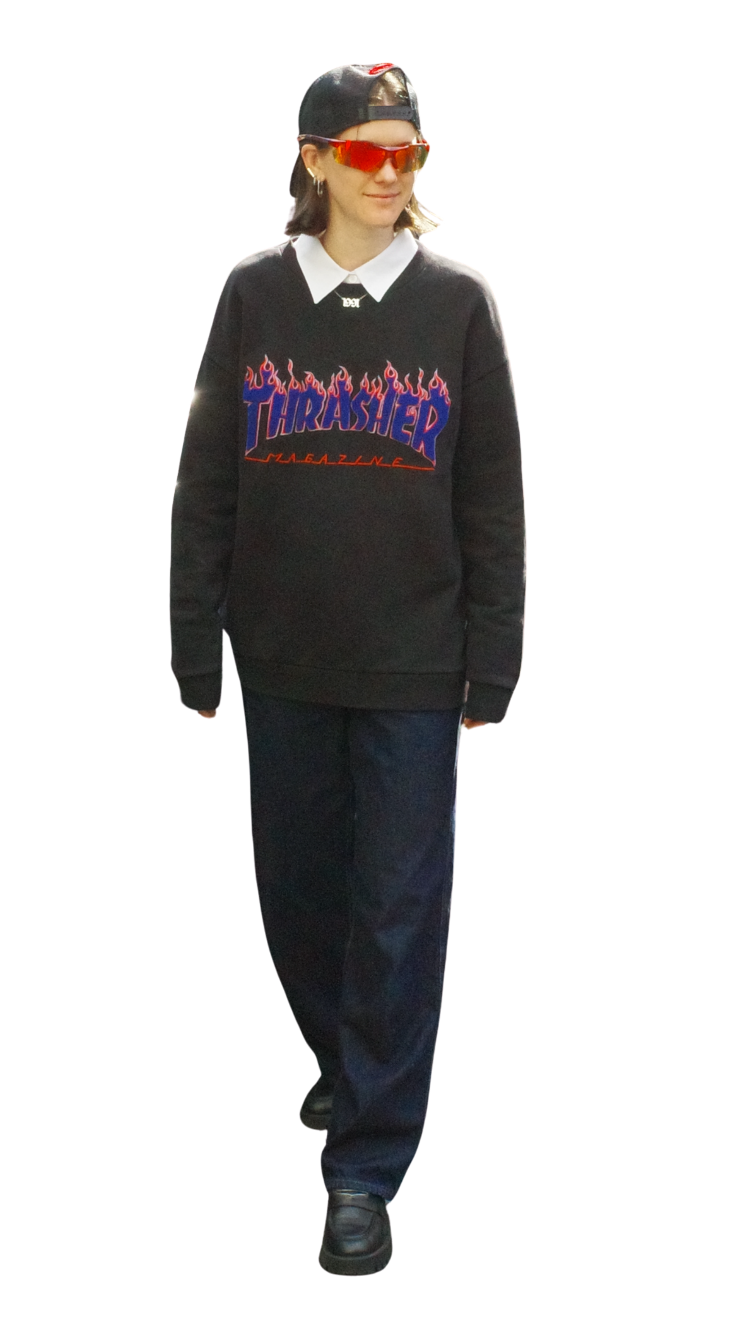 Person wearing a black Thrasher Magazine sweatshirt, white collared shirt underneath, black baseball cap worn backwards, red sunglasses, dark jeans, and black shoes