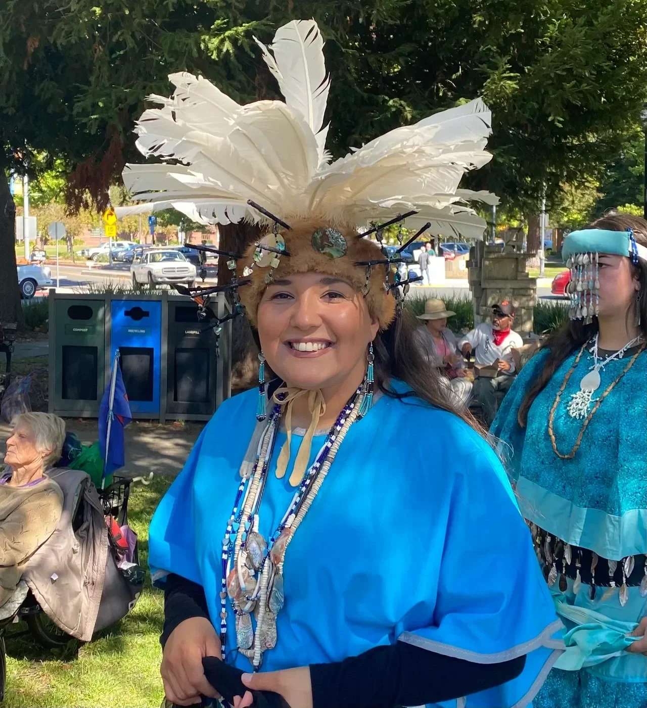 native-woman-smiling-in-blue-regalia.webp