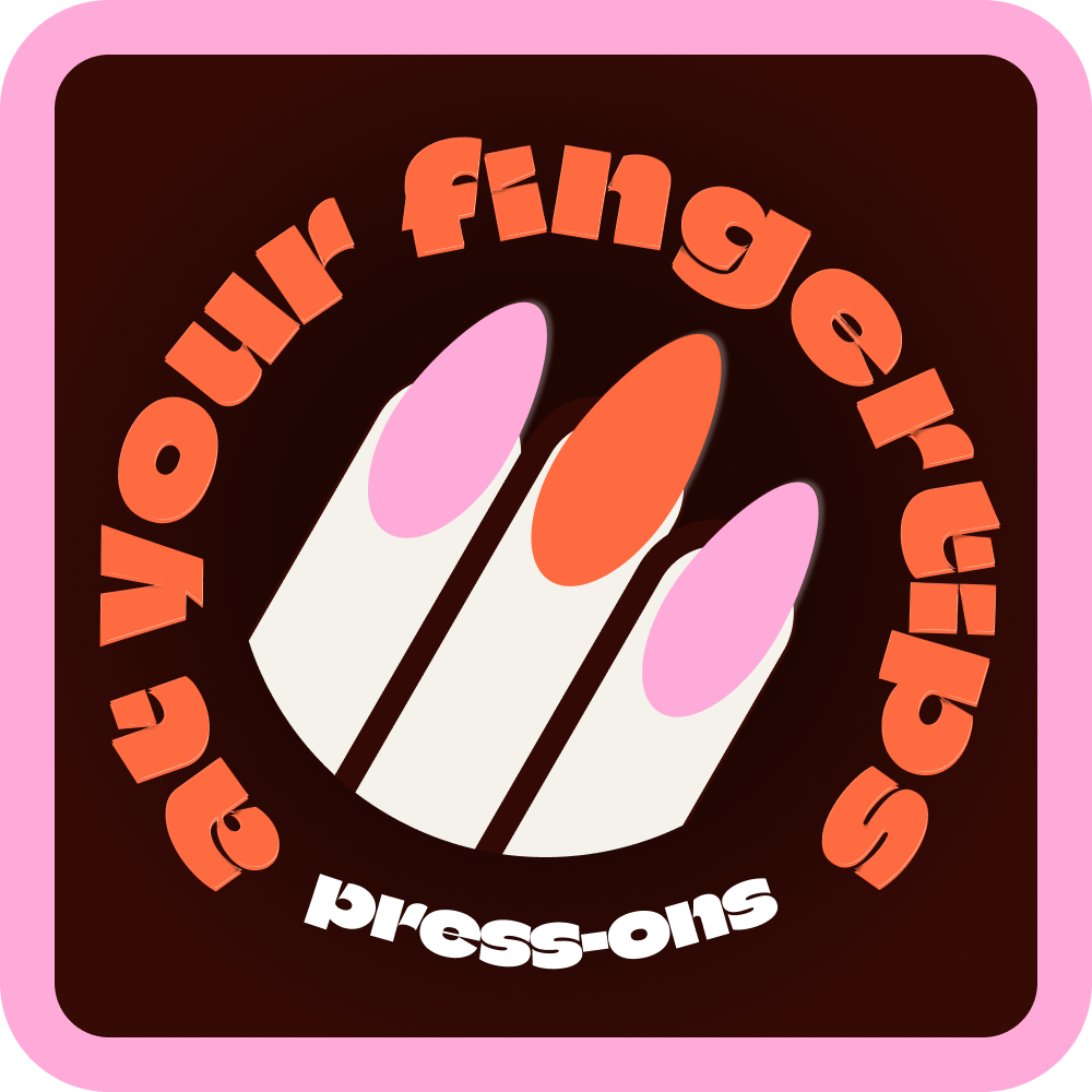 A logo with a pink border and a dark brown background, featuring a stylized hand with three fingers painted with pink, orange, and pink nail polish. Text around the hand reads 'at your fingertips | press on nails'