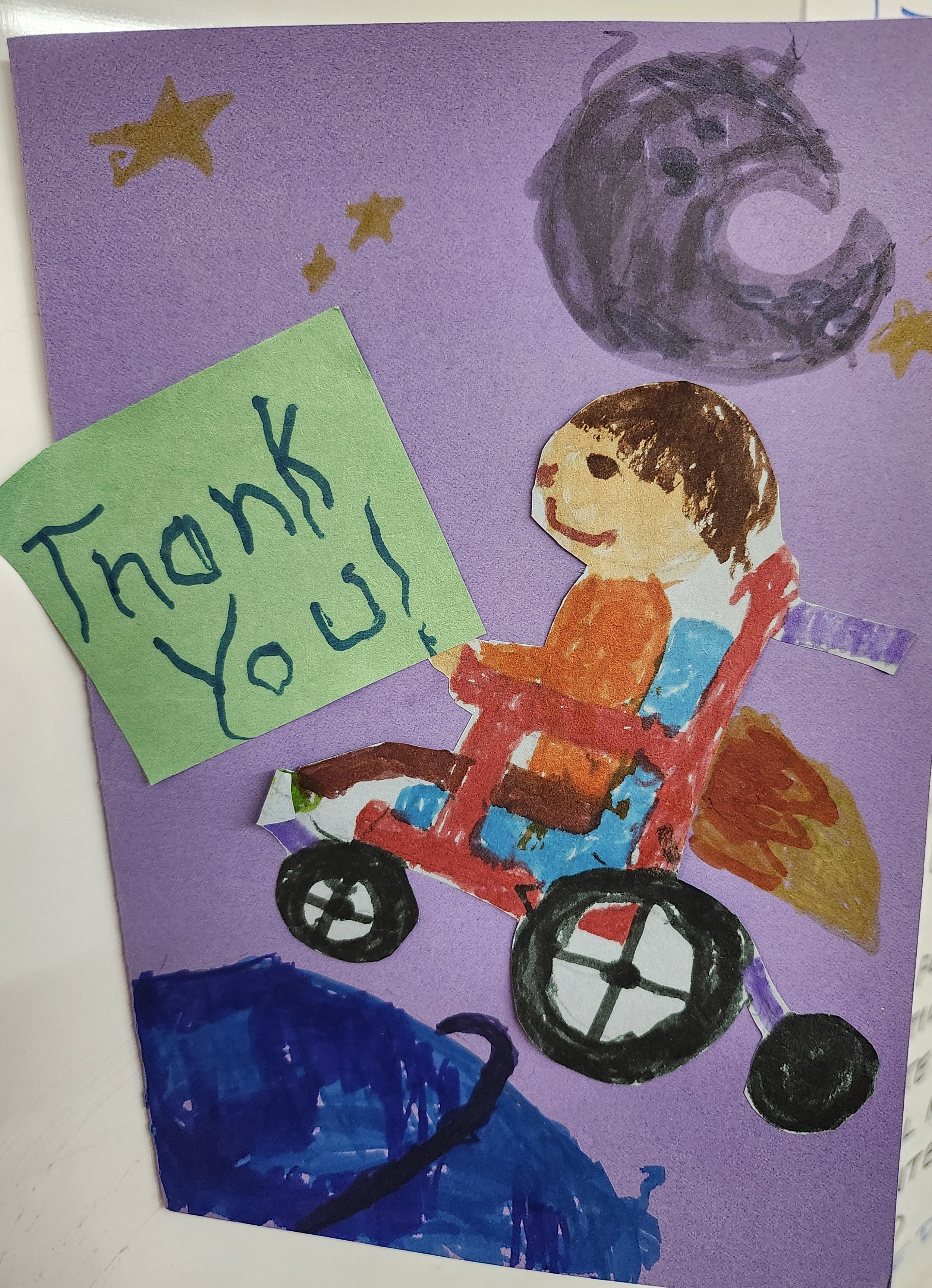 Image of a child in a wheelchair with a jet engine and THANK YOU text