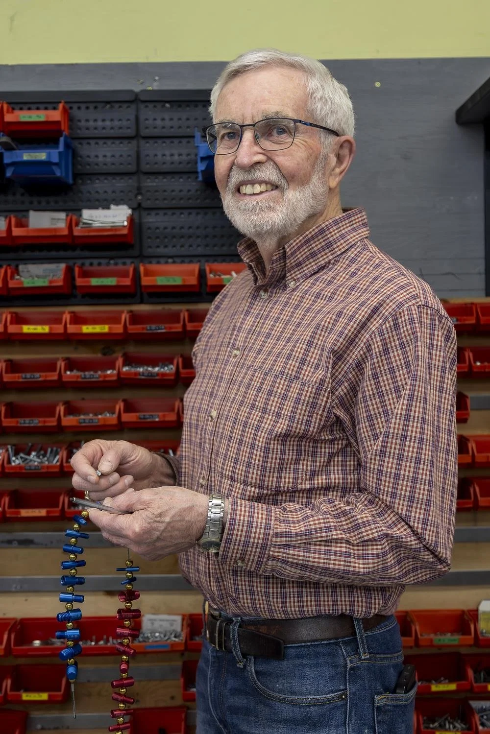 Cam Reid, Ability Workshop board member, in the workshop assembling adaptive equipment hardware