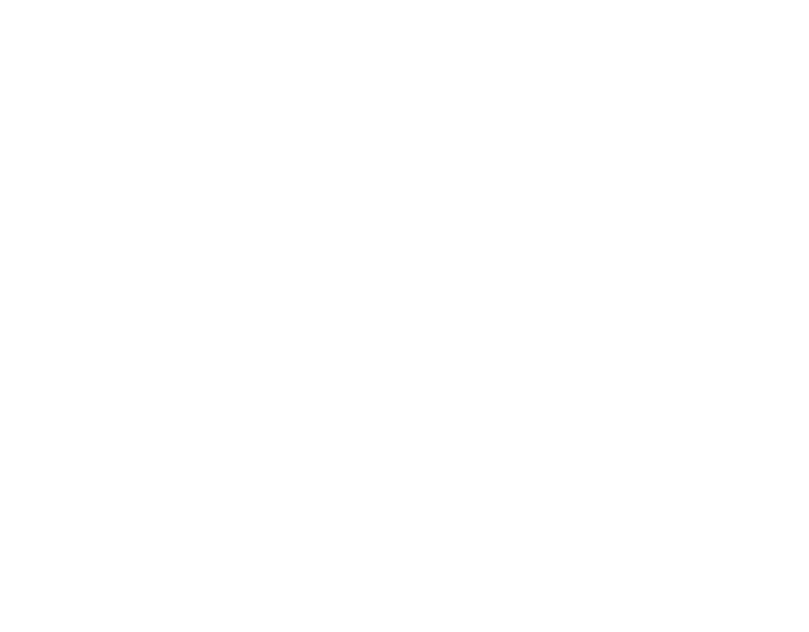 A white cordless electric drill lying on a gray surface with a screw bit attached.