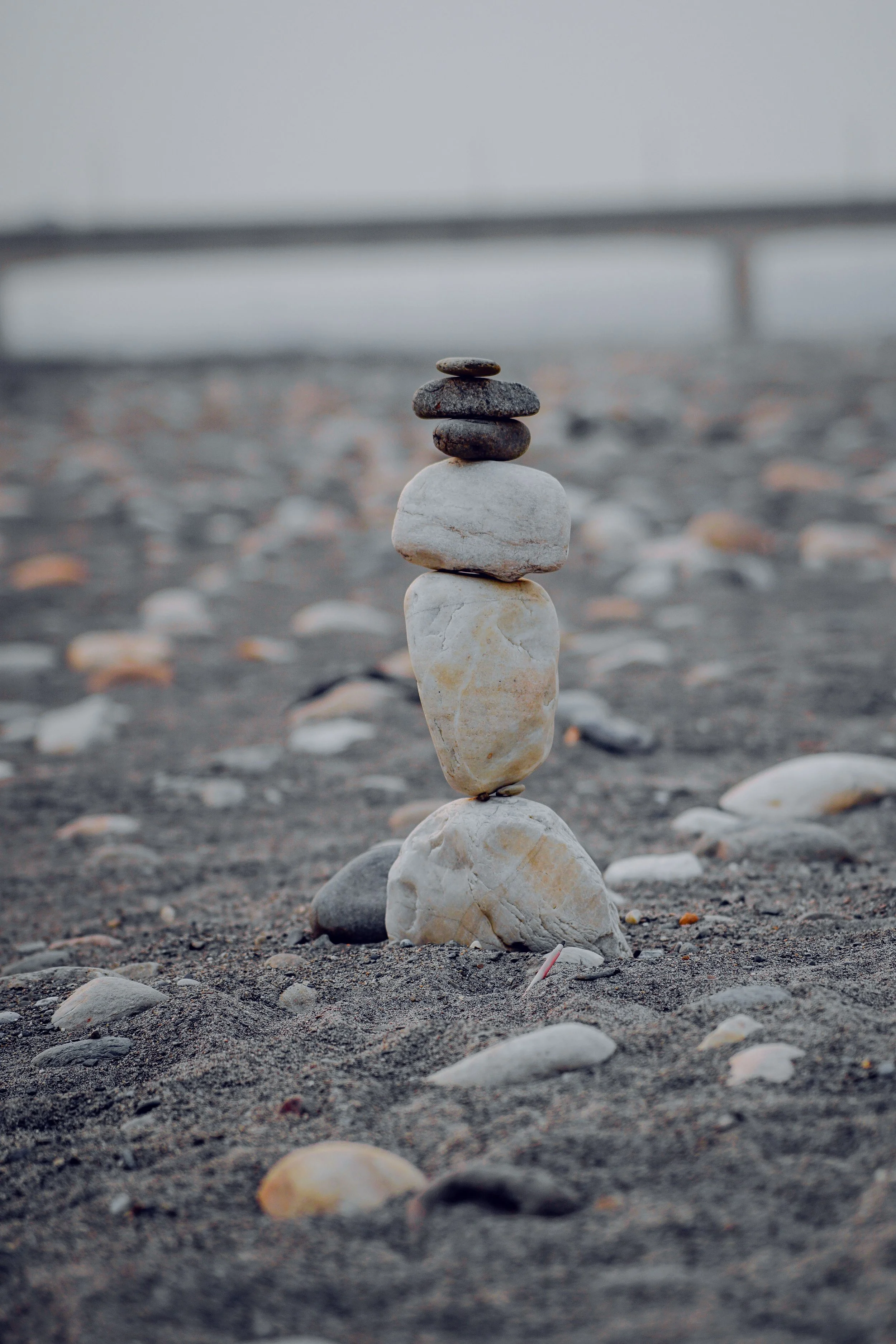 Stacked smooth stones on a sandy beach