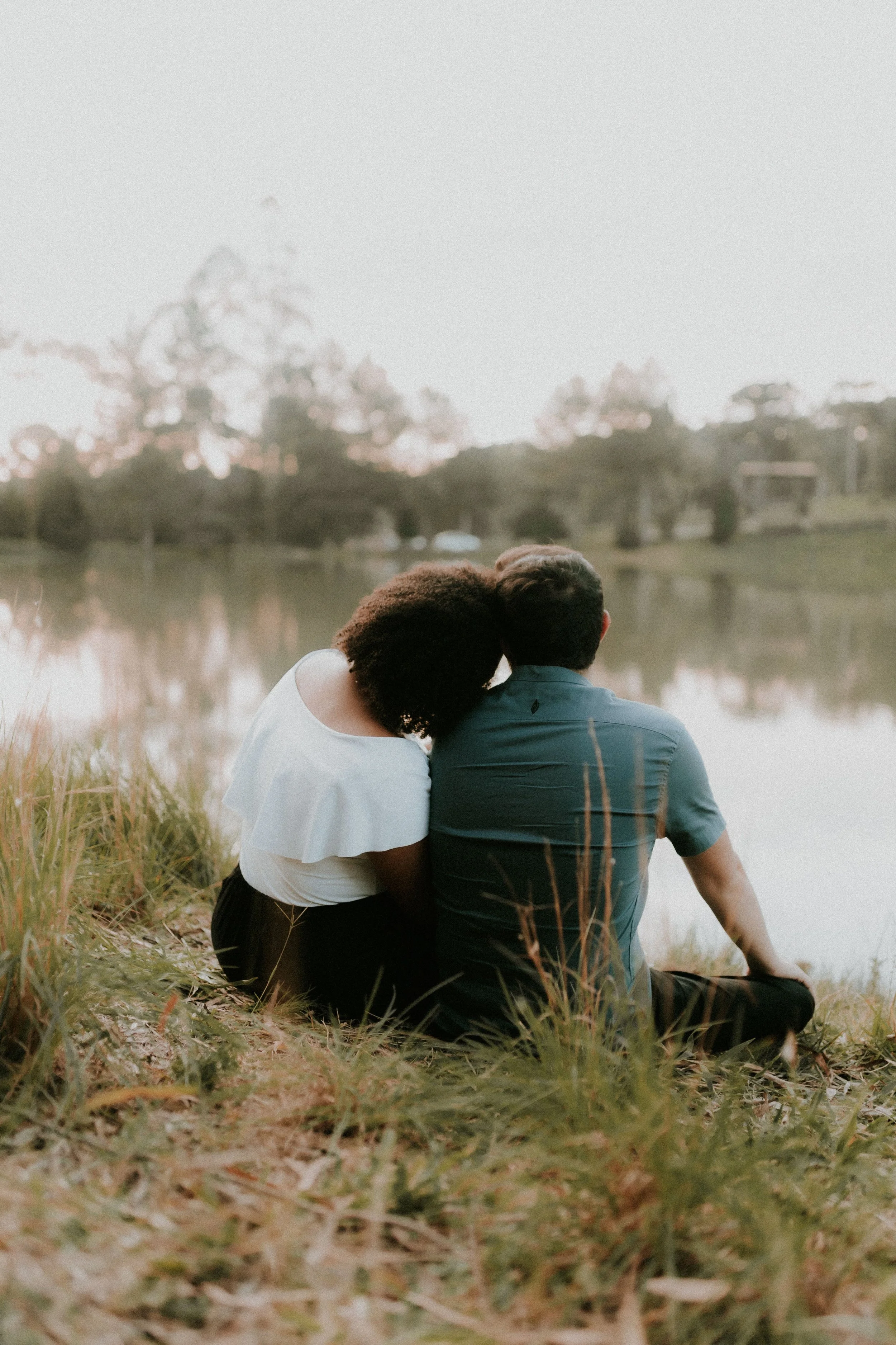 Couple sitting together by the water representing connection and relationships