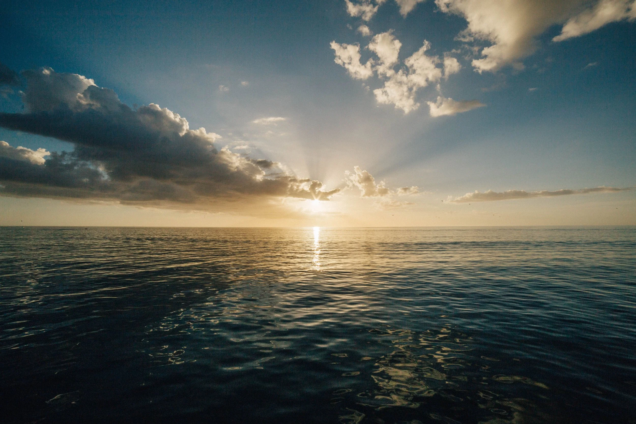 Sunlight over the ocean representing calm and healing after trauma