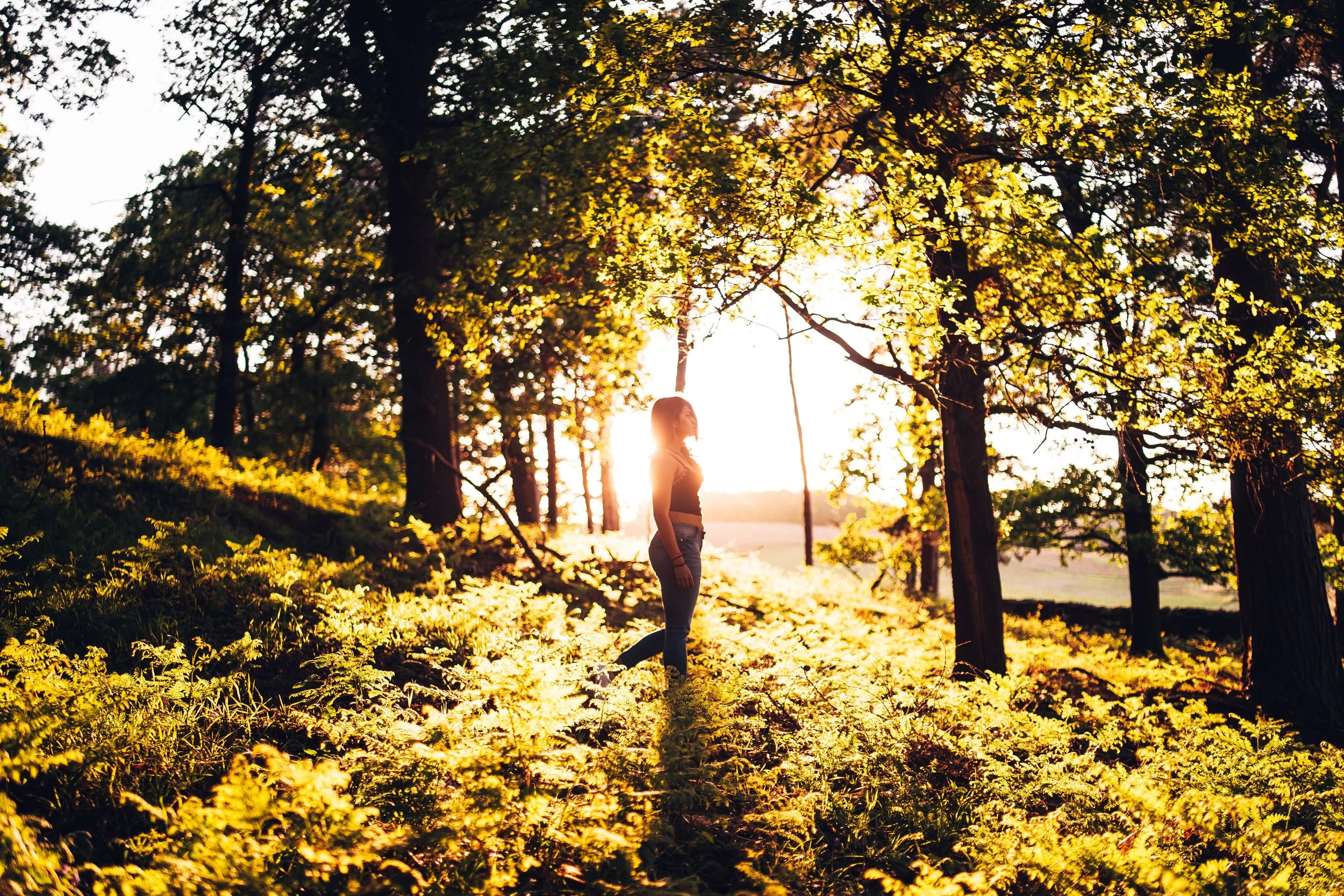 Woman standing alone in nature reflecting on relationship and attachment patterns