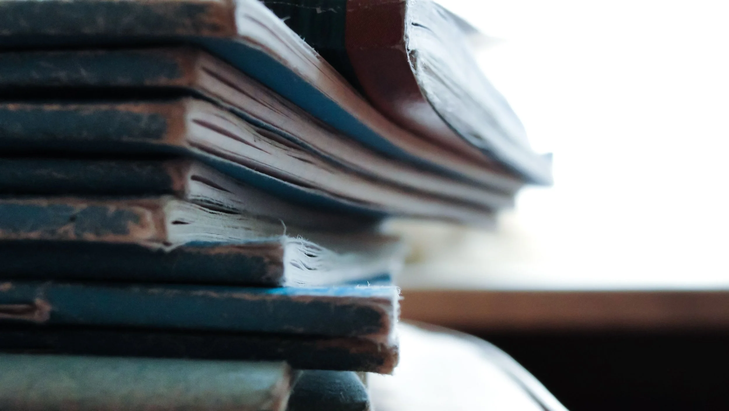 Stack of journals representing reflection and personal stories