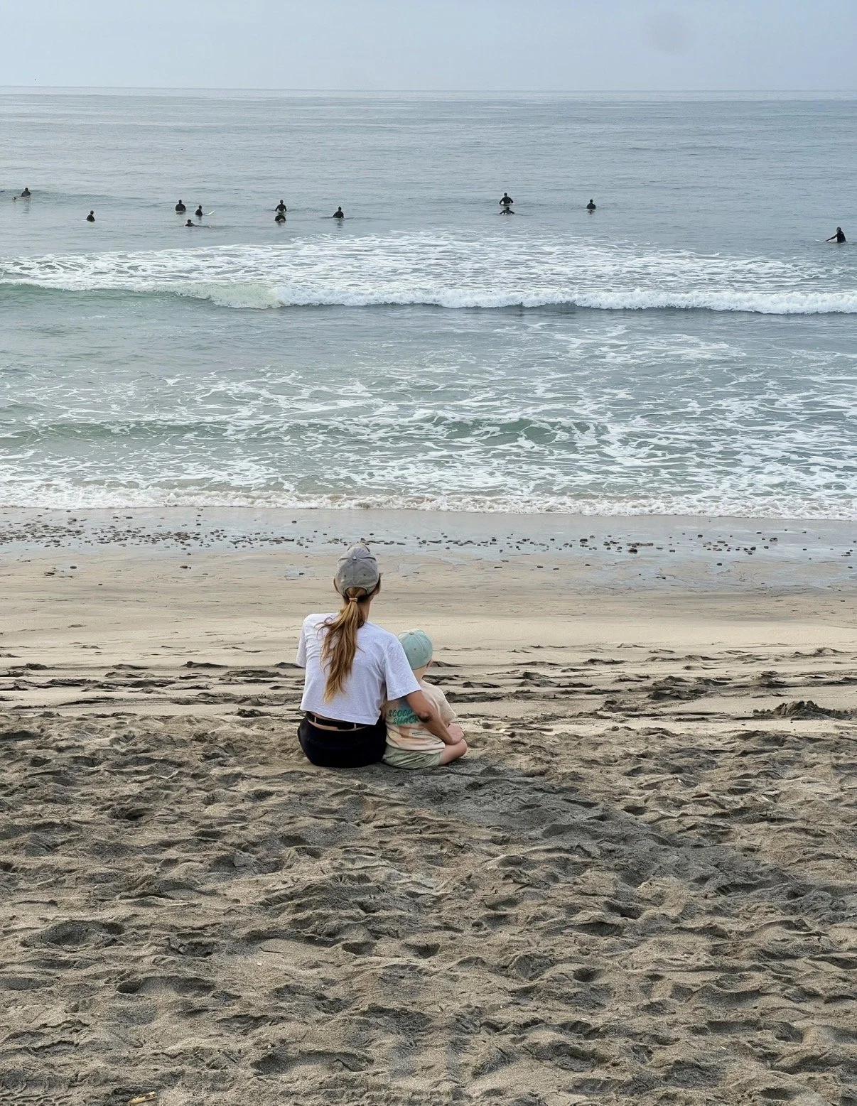 Chelsea Roush sitting on the beach in Carlsbad, California