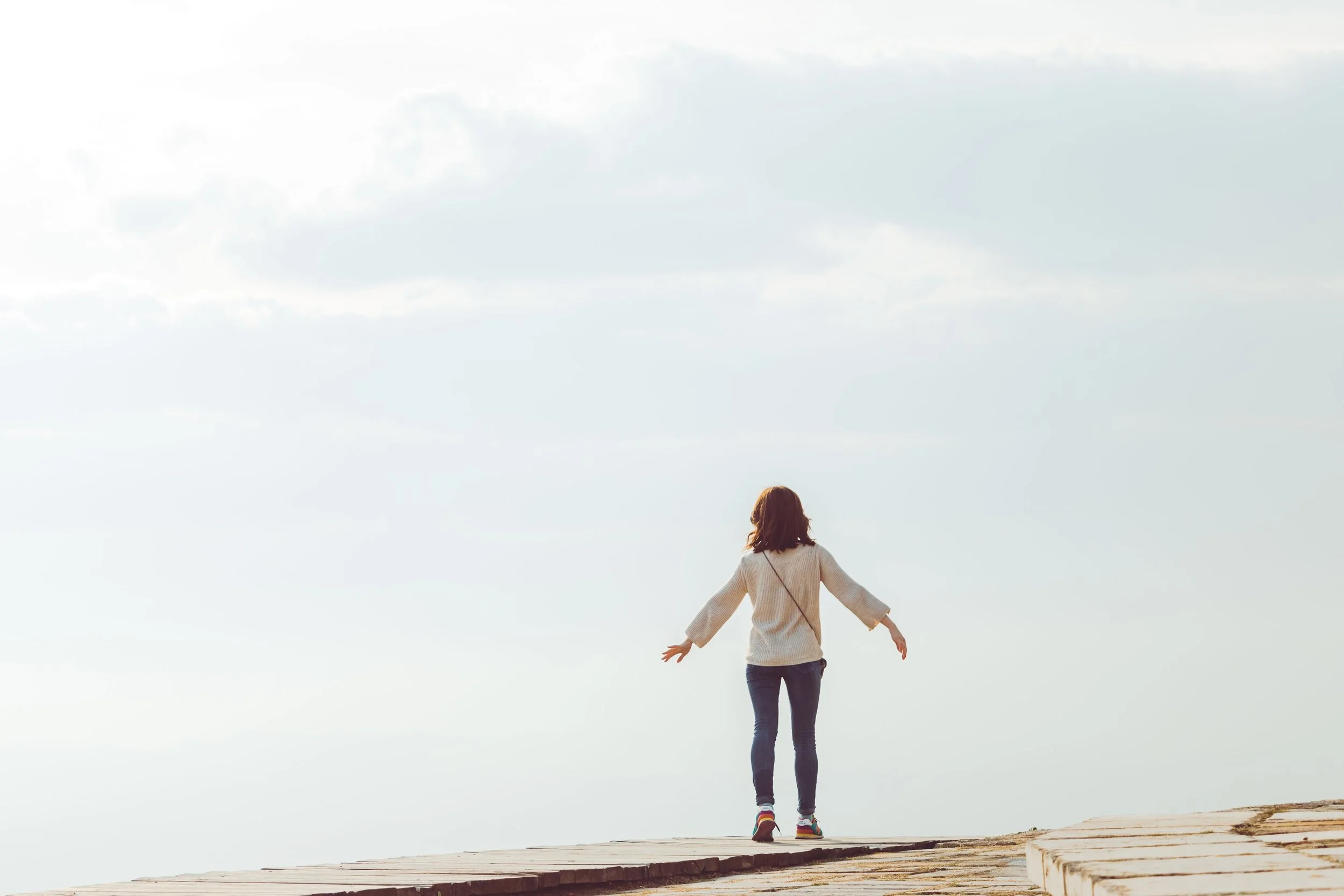 walking/balancing Woman taking a step forward representing the beginning of the therapy process