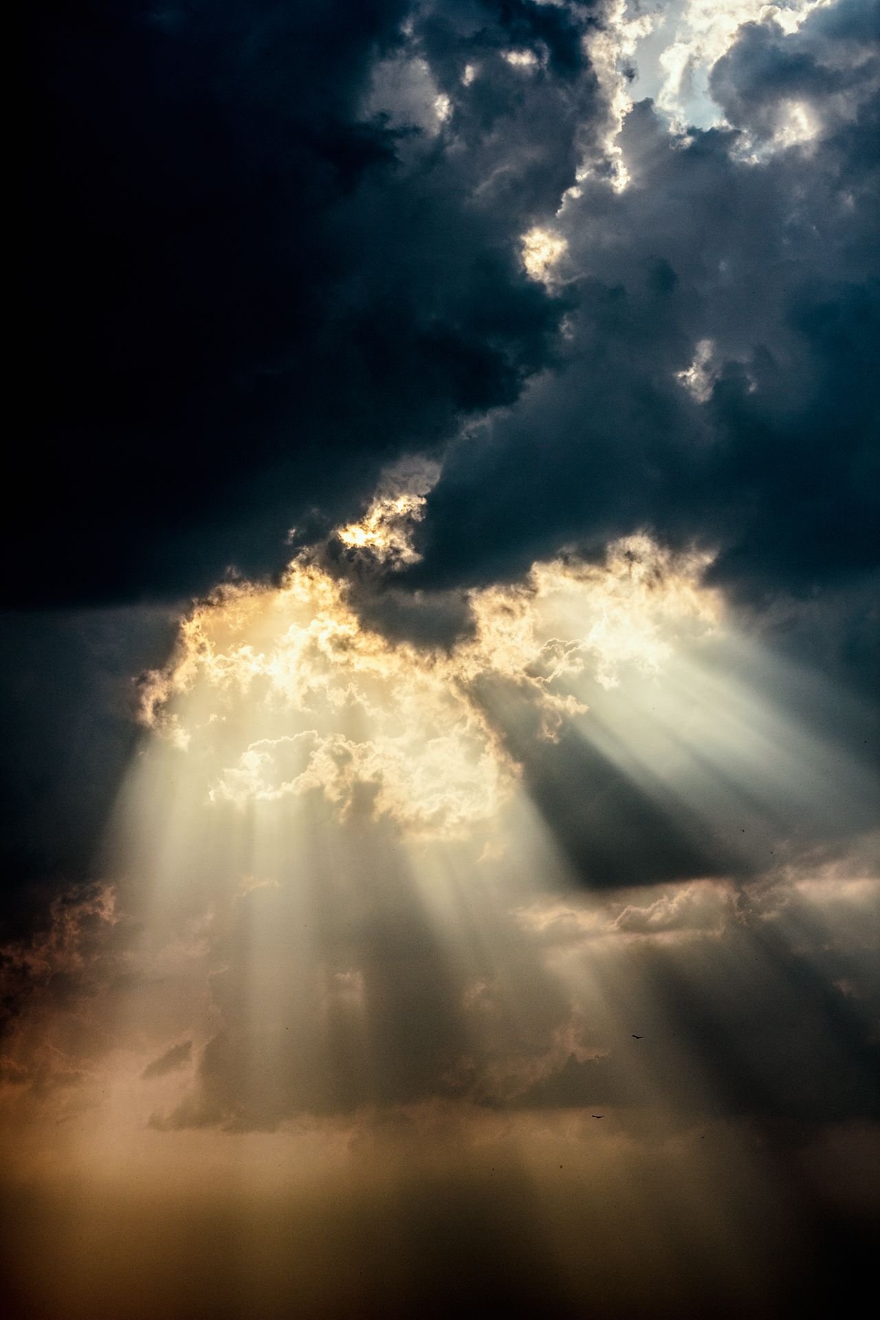Sunlight breaking through storm clouds representing hope after difficult experiences