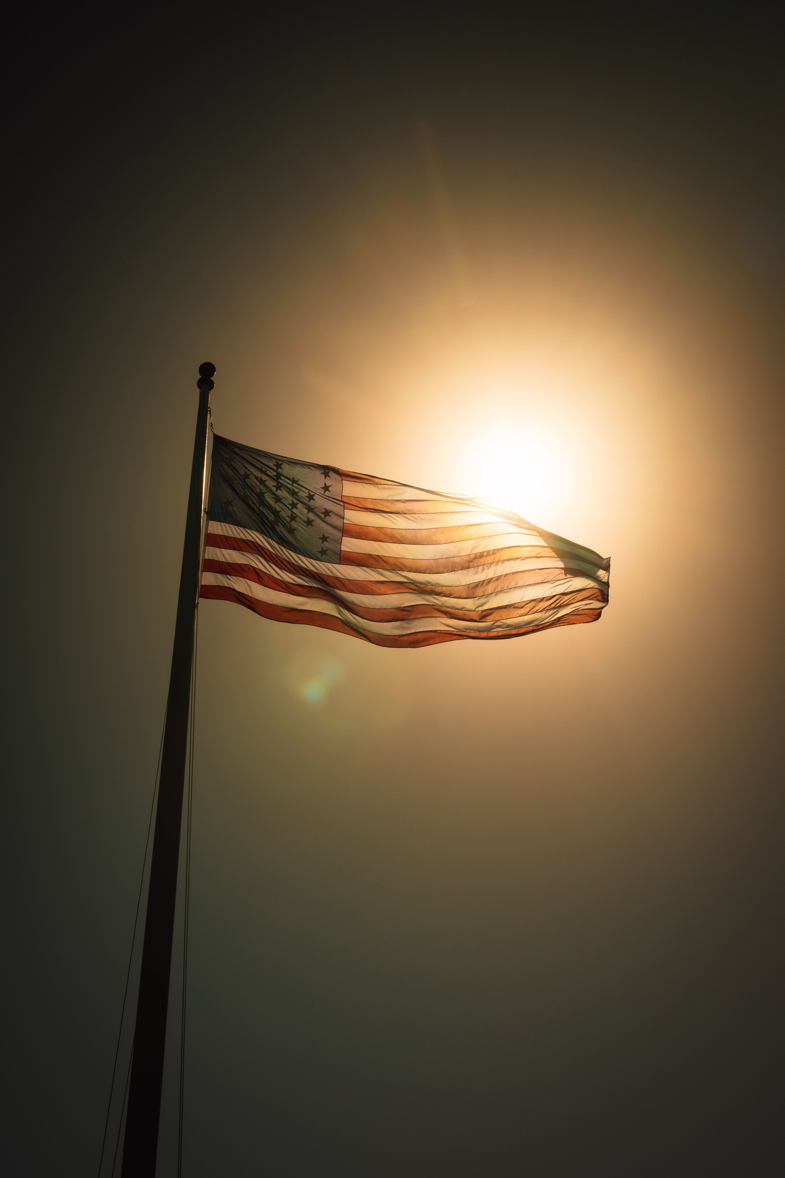 American flag in sunlight representing military members, veterans, and first responders