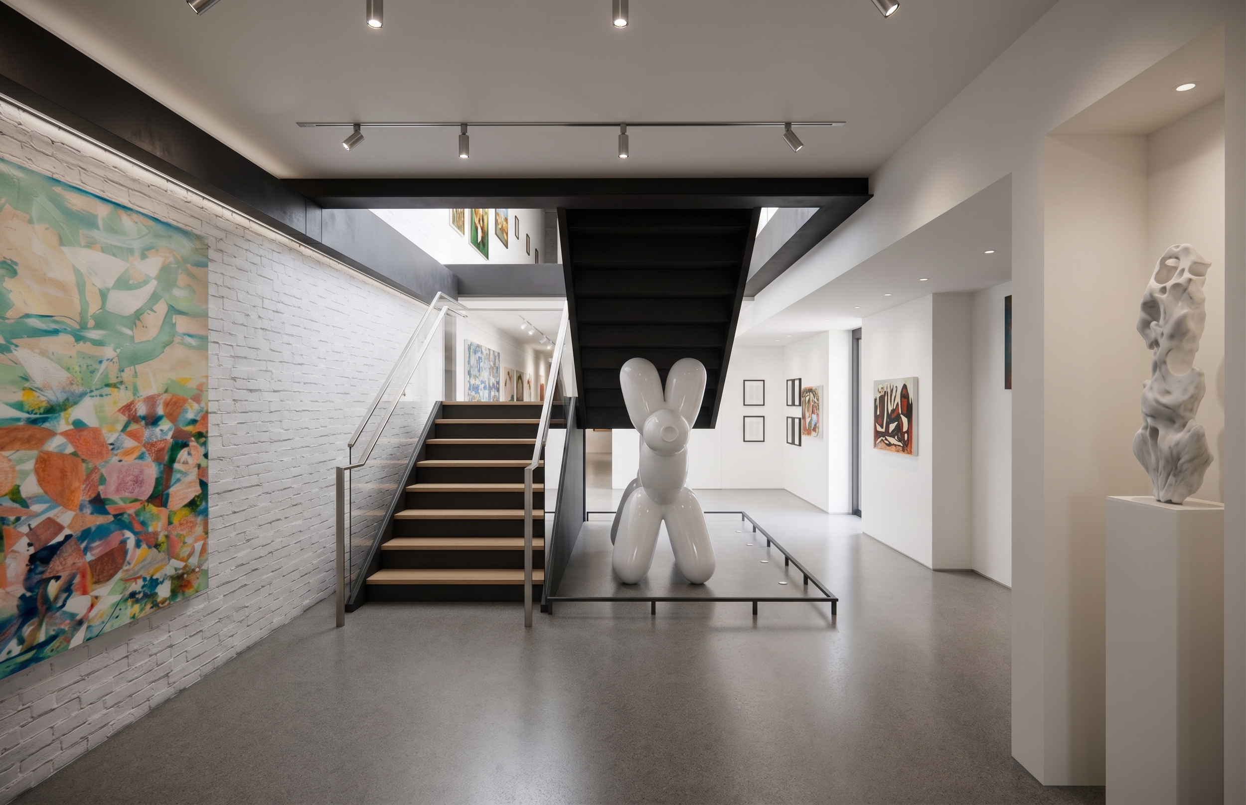Modern art gallery interior with white walls, artwork, abstract sculptures, and a black staircase.