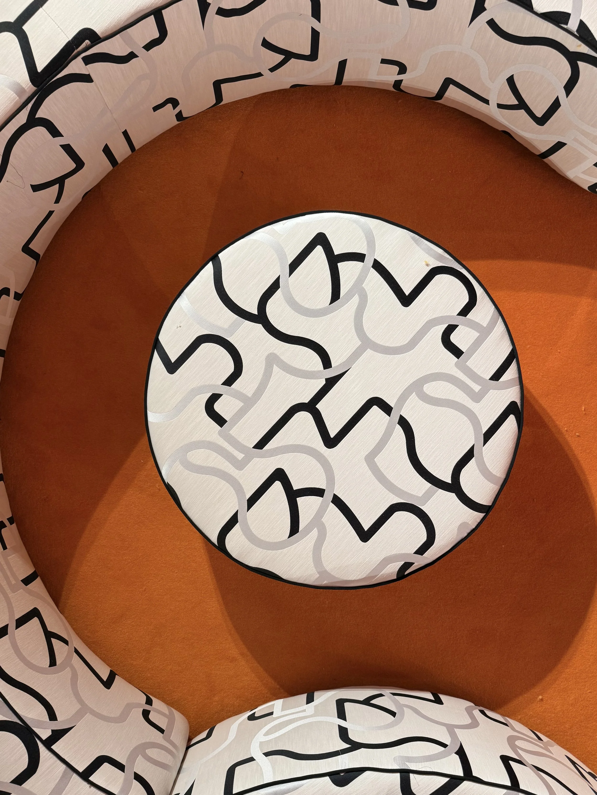 Close-up of a patterned paper cone with black, white, and gray abstract lines, interior lined with orange material.