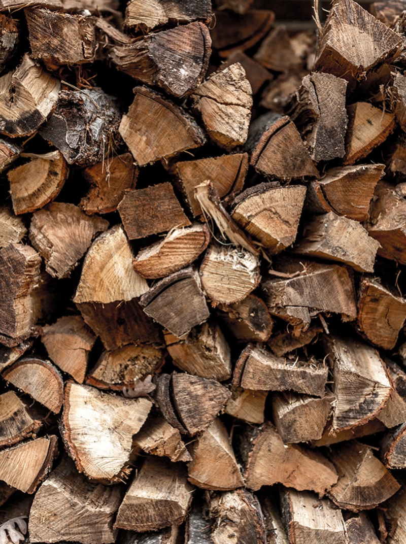 Close-up of a pile of stacked split firewood logs