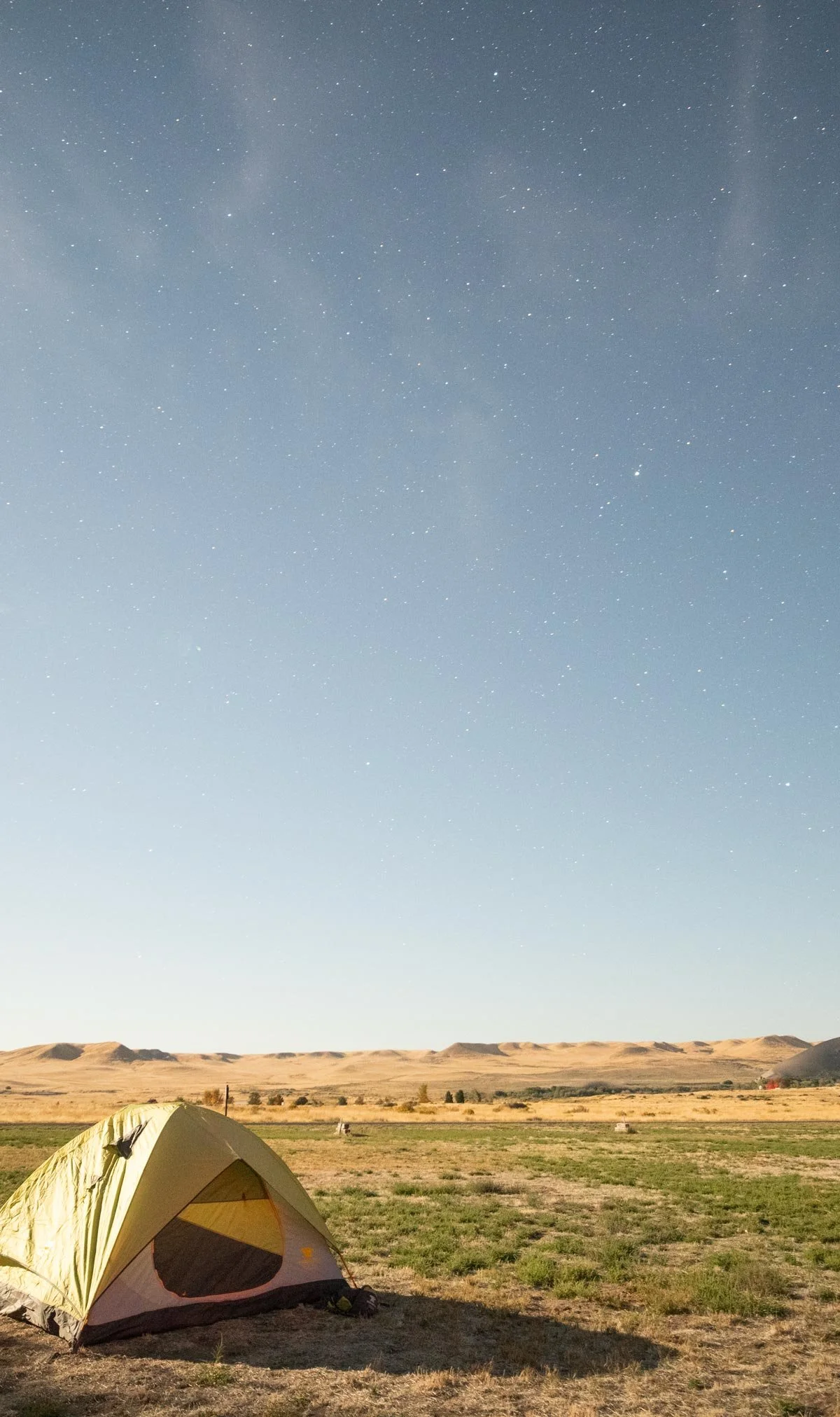 Tent in an open desert landscape under the stars