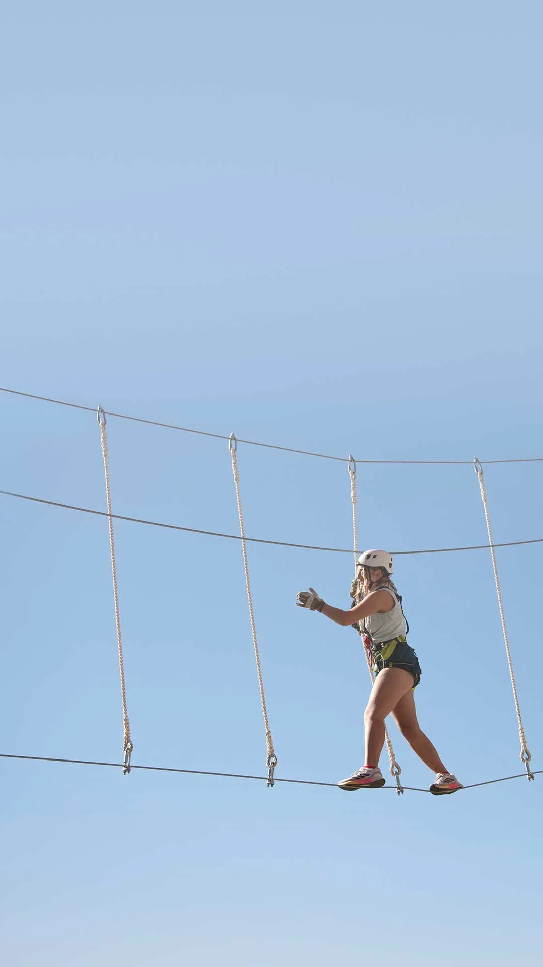Girl walking along tightrope course