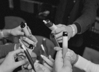 Nicotine and vapes — hands holding vape devices