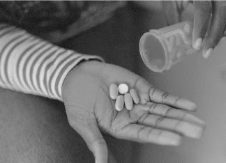 Prescription medications — pills in a hand