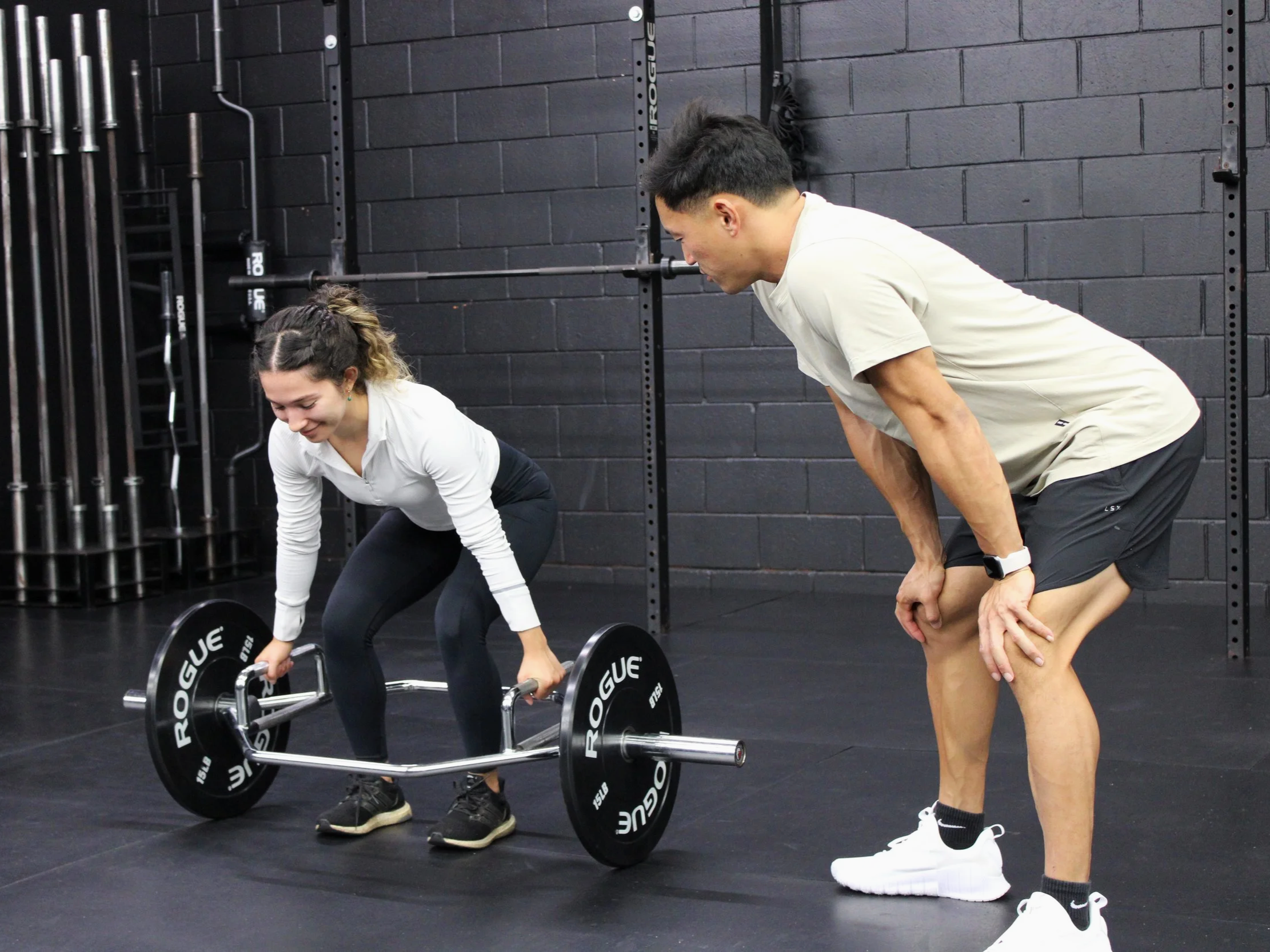 Personal trainer coaching a woman the deadlift during a personal training session in Ocean Beach, San Diego.