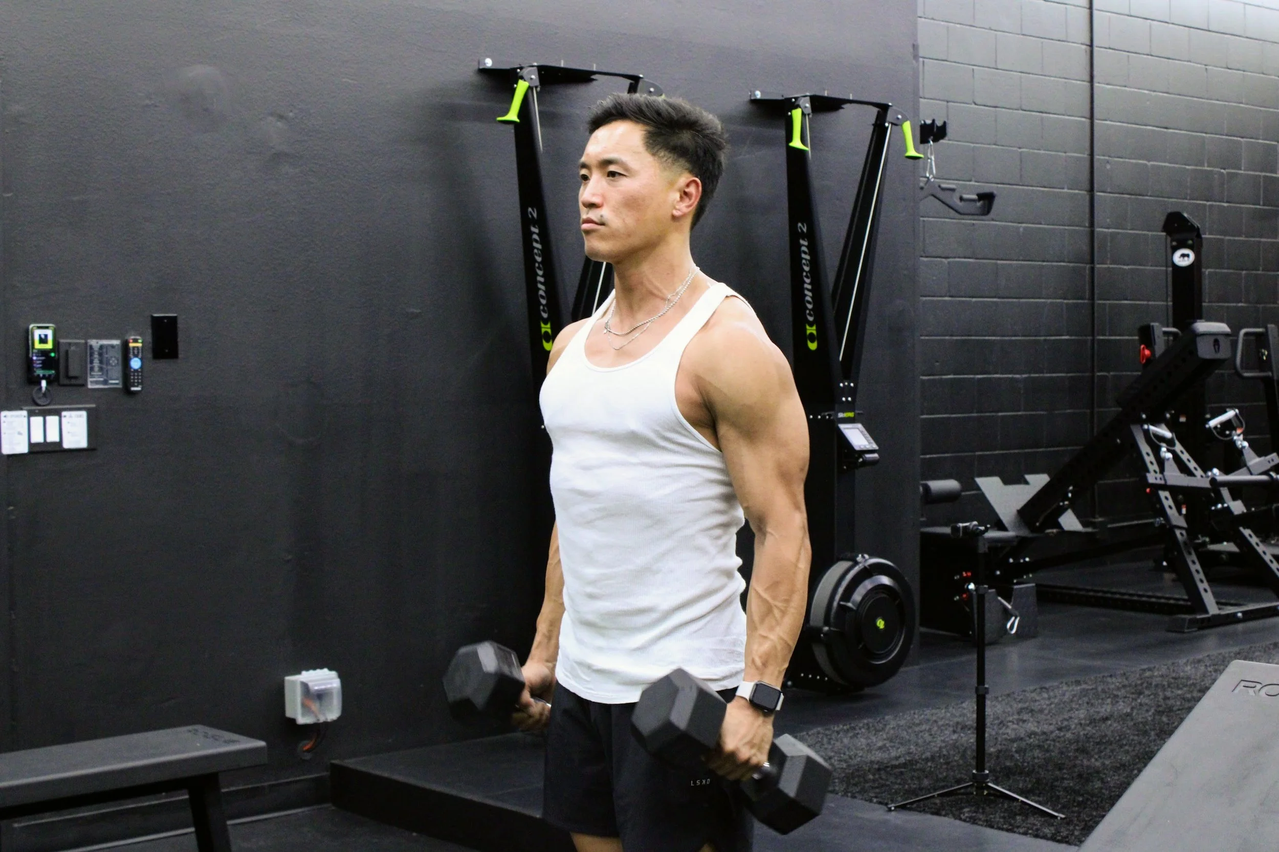 Certified personal trainer Jeff Jun doing dumbbell exercises at a gym near Bay Park and La Mesa