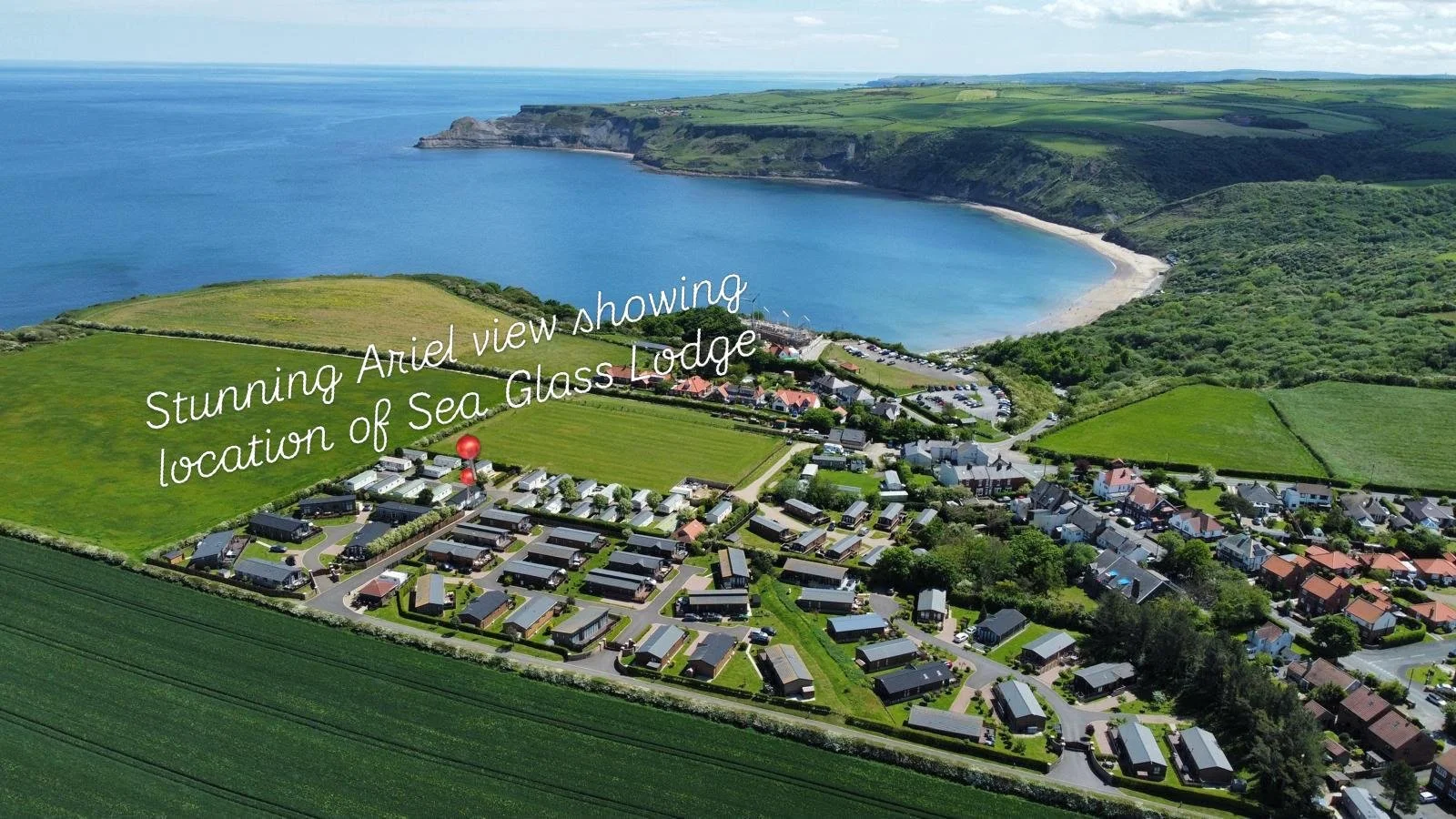 An aerial view of Ariel, showing location of Sea Glass Lodge in the coastal village of Runswick Bay, near the sea with long sandy dog friendly beach