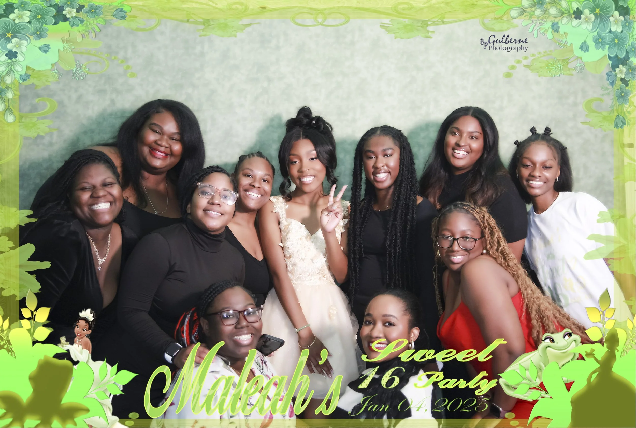 A group of women and girls at a party with a green floral themed background, smiling and posing for the photo. Text on the image reads "Mahlah's Sweet 16 Party, Jan 04, 2025" with cartoon characters from Disney's Moana.