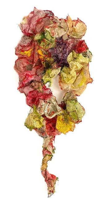 A tornado made of crumpled, colorful pieces of paper in shades of red, yellow, green, and purple.