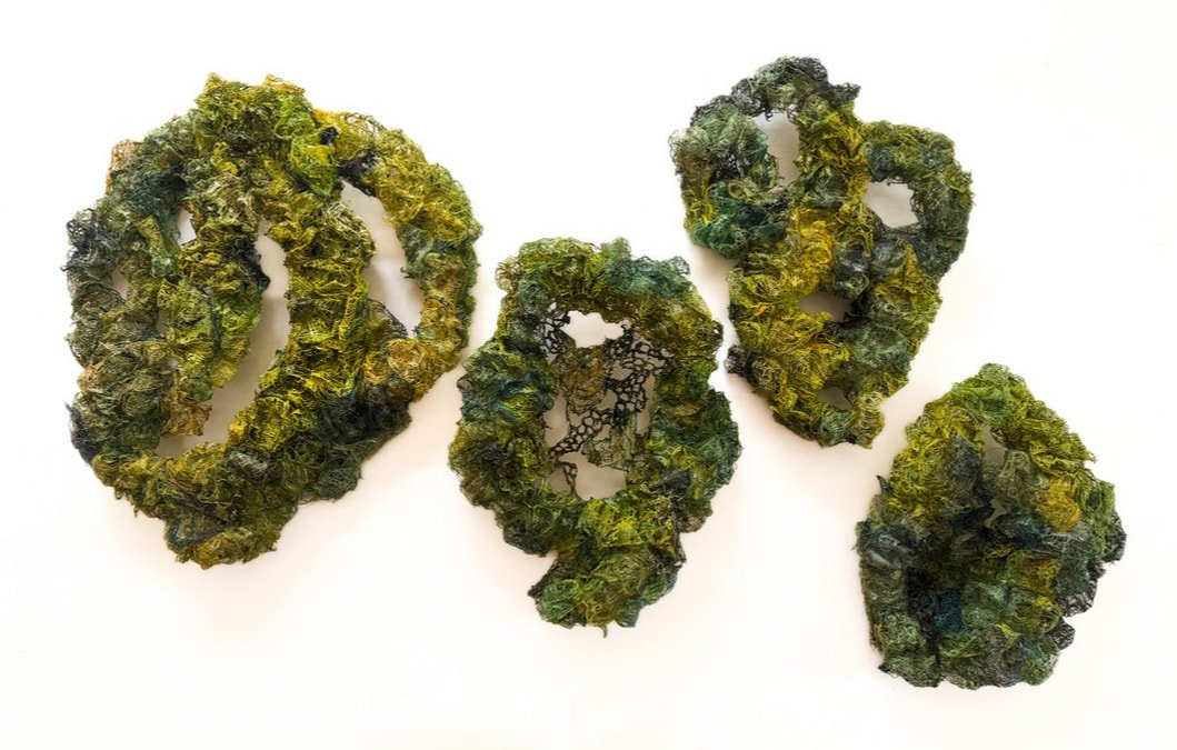 Four cannabis buds on a white background.