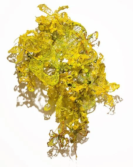 A piece of gold leaf with a crinkled, irregular surface and uneven edges.