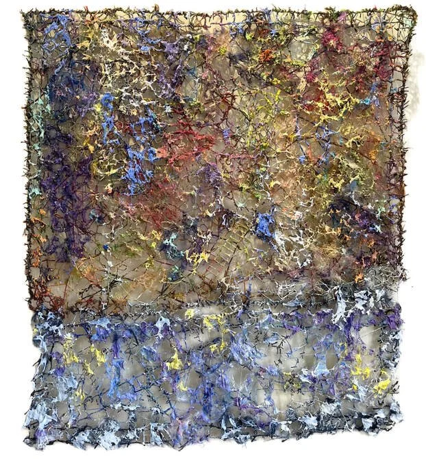 An abstract mixed media artwork featuring a textured, web-like surface with a mix of vibrant colors including blue, purple, yellow, green, and red, arranged in an organic, chaotic pattern.