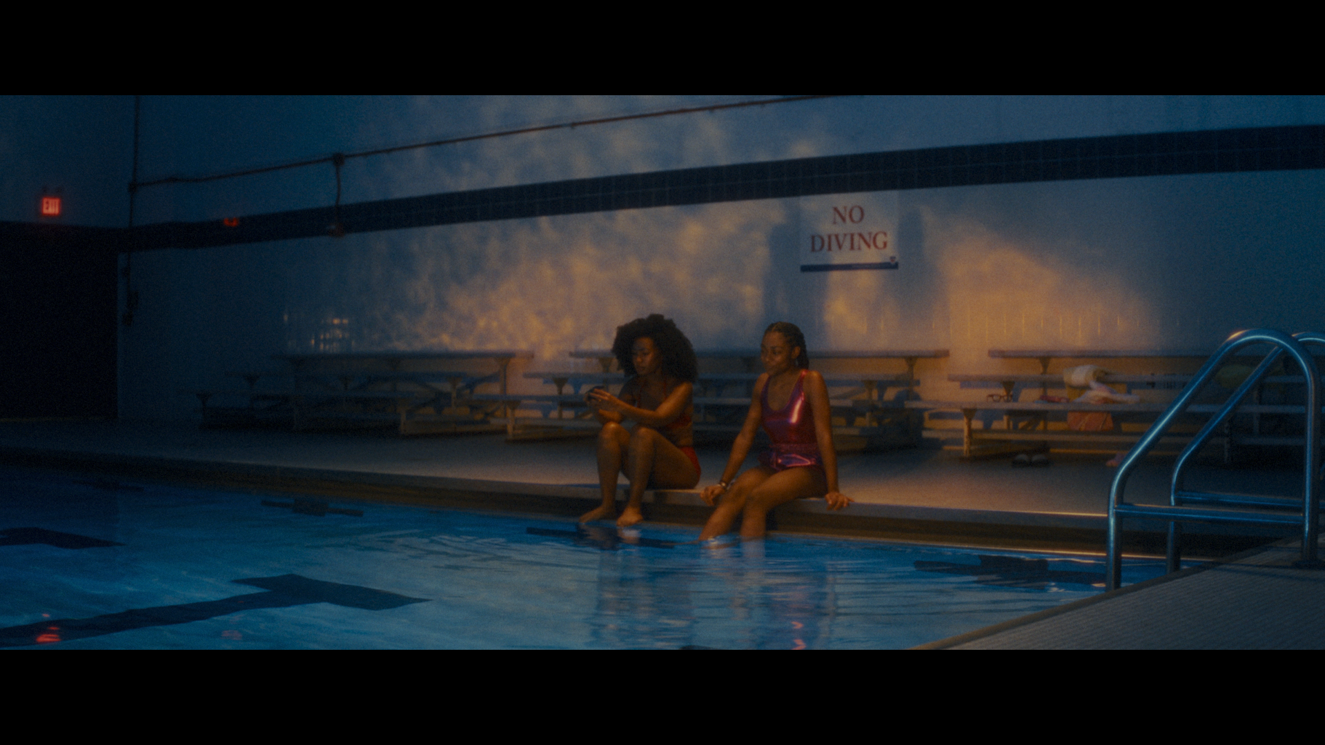 Cassidy and Elle sitting at the edge of a pool in Betta Fish