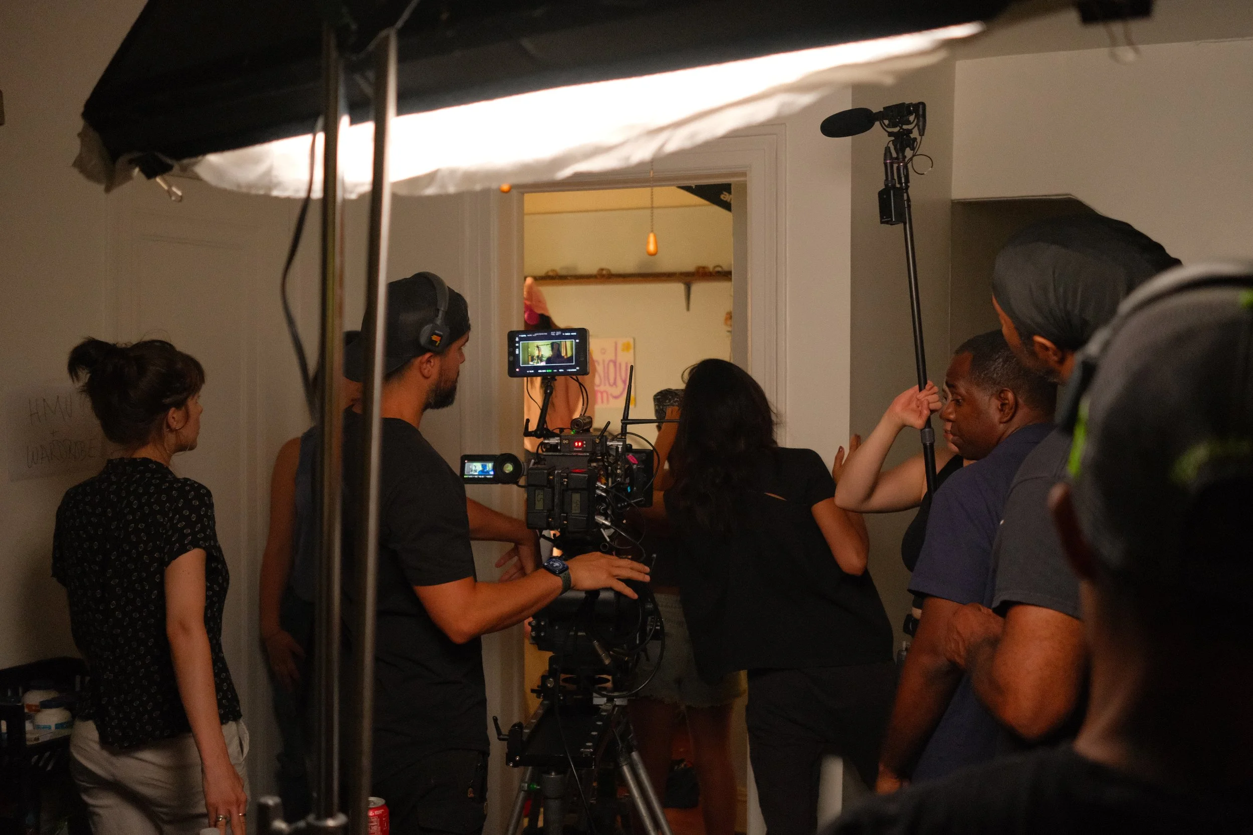 Betta Fish crew setting shooting a scene in the doorway of a bedroom