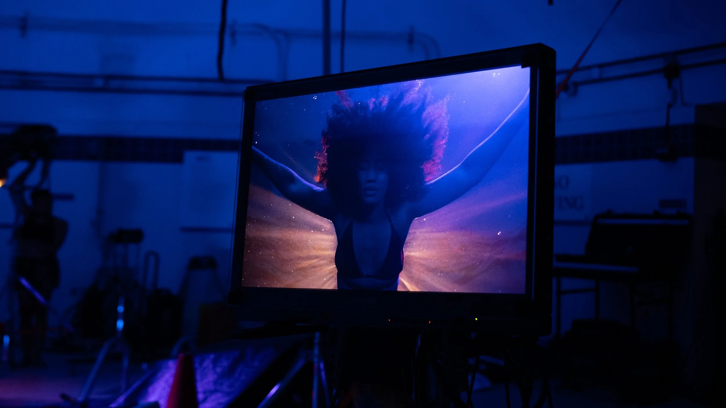 Elle floating in a blue and purple abyss displayed on a DIT Monitor from the short film Betta Fish