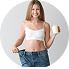 Young woman wearing a white sleeveless crop top and blue jeans