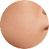 Close-up of a peach-colored, smooth-skinned object, possibly a portion of a round fruit or a similar surface.